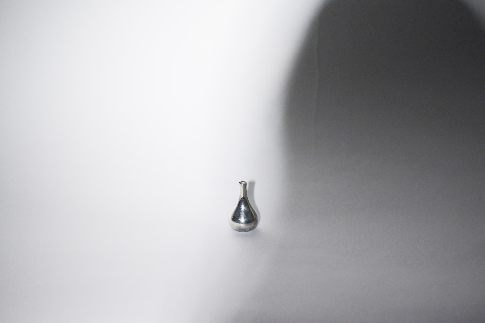 The candle holder's modern teardrop silouhette makes for a sculptural tabletop piece. Designed by Danish sculptor and designer Jens Quistgaard.