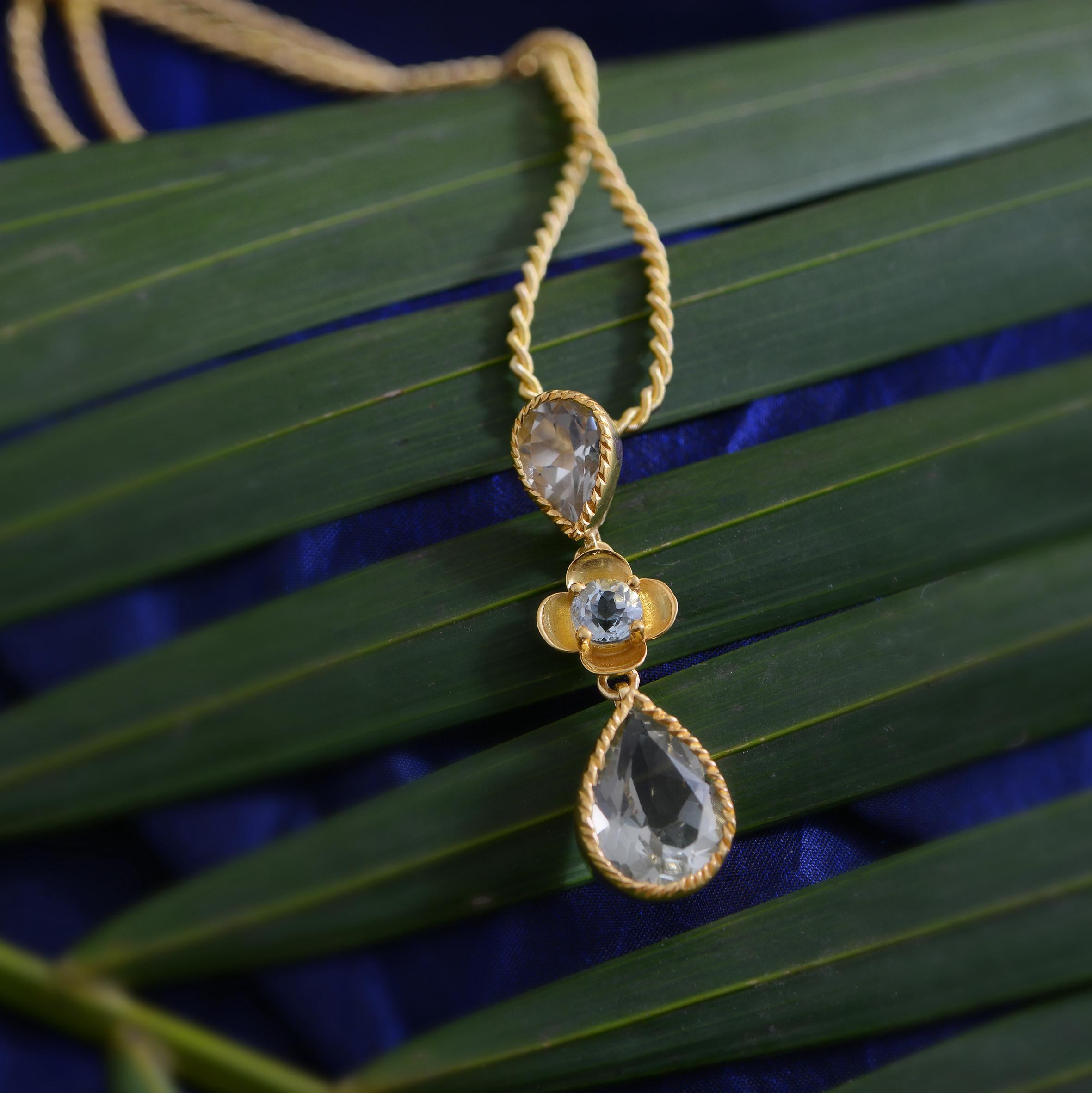 A lovely limited edition green amethyst aquamarine teardrop shaped pendant.

The pendant is made in sterling silver coated in 24ct gold vermeil and features teardrop shaped faceted green amethysts with a central aquamarine. It comes with a 26 inch