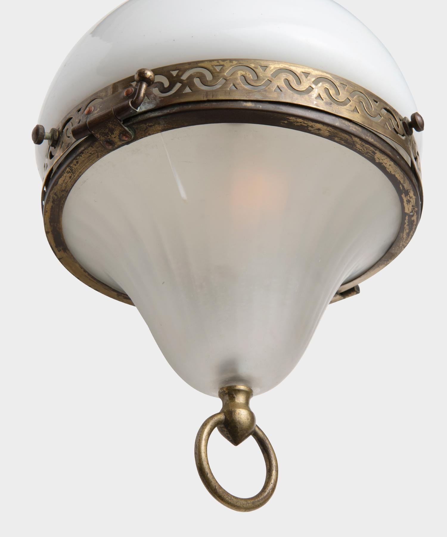 Petite opaline and frosted glass pendant with ornate brass details. Small crack in lower shade, shown in photos.
    