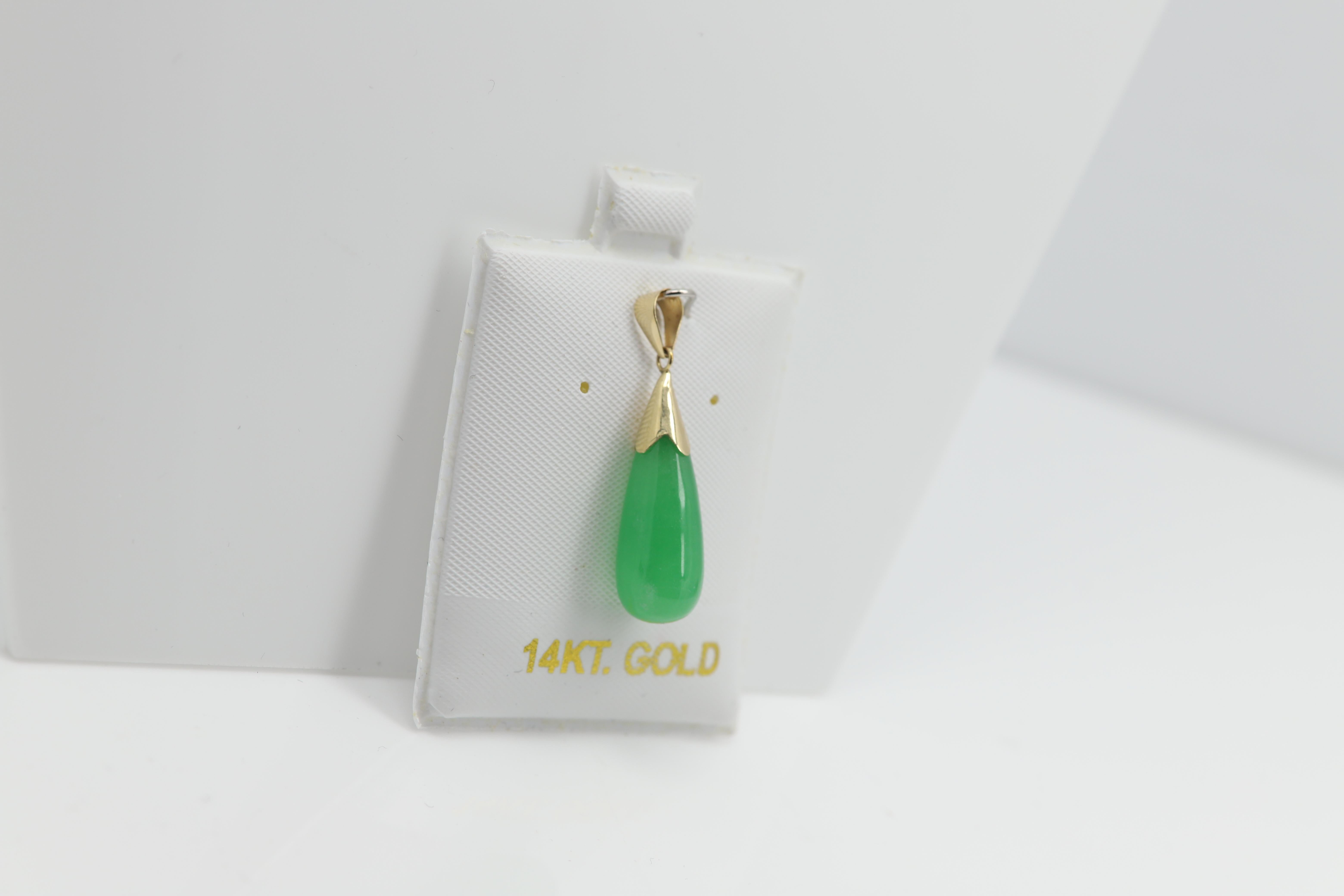 Beautiful Jade Drop Pendant
14k Yellow Gold (solid gold)
Natural jade but color treated (type of treatment is very popular and common).
overall weight 2.2 grams.
Size: approx  Stone size 20 mm long and 8mm width in in the widest area(0.75' inch