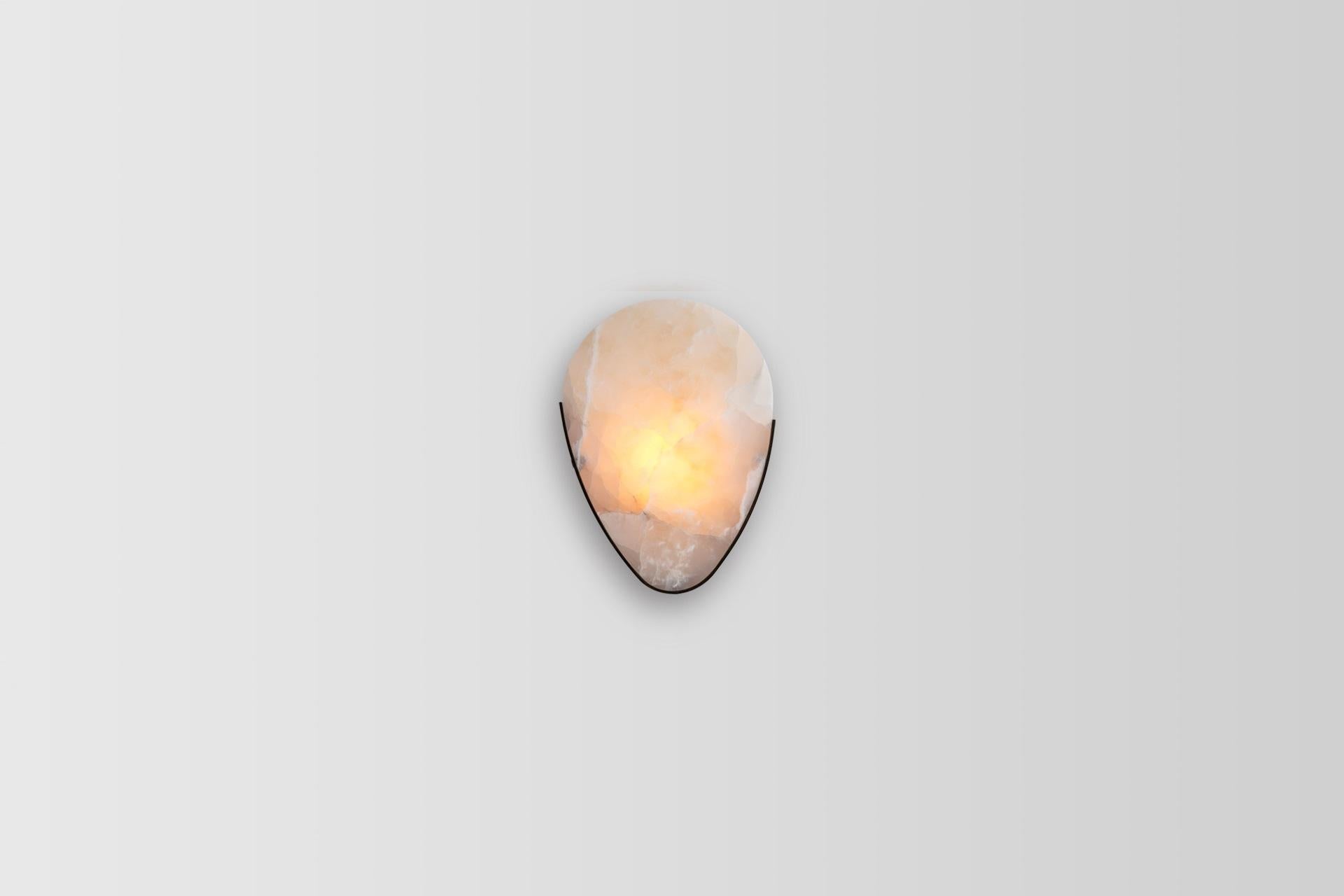 Teardrop marble wall lamp by Atra Design.
Dimensions: D 28 x W 15 x H 38 cm
Materials: Taj Mahal marble, brass

Atra Design
We are Atra, a furniture brand produced by Atra form a mexico city–based high end production facility that also houses