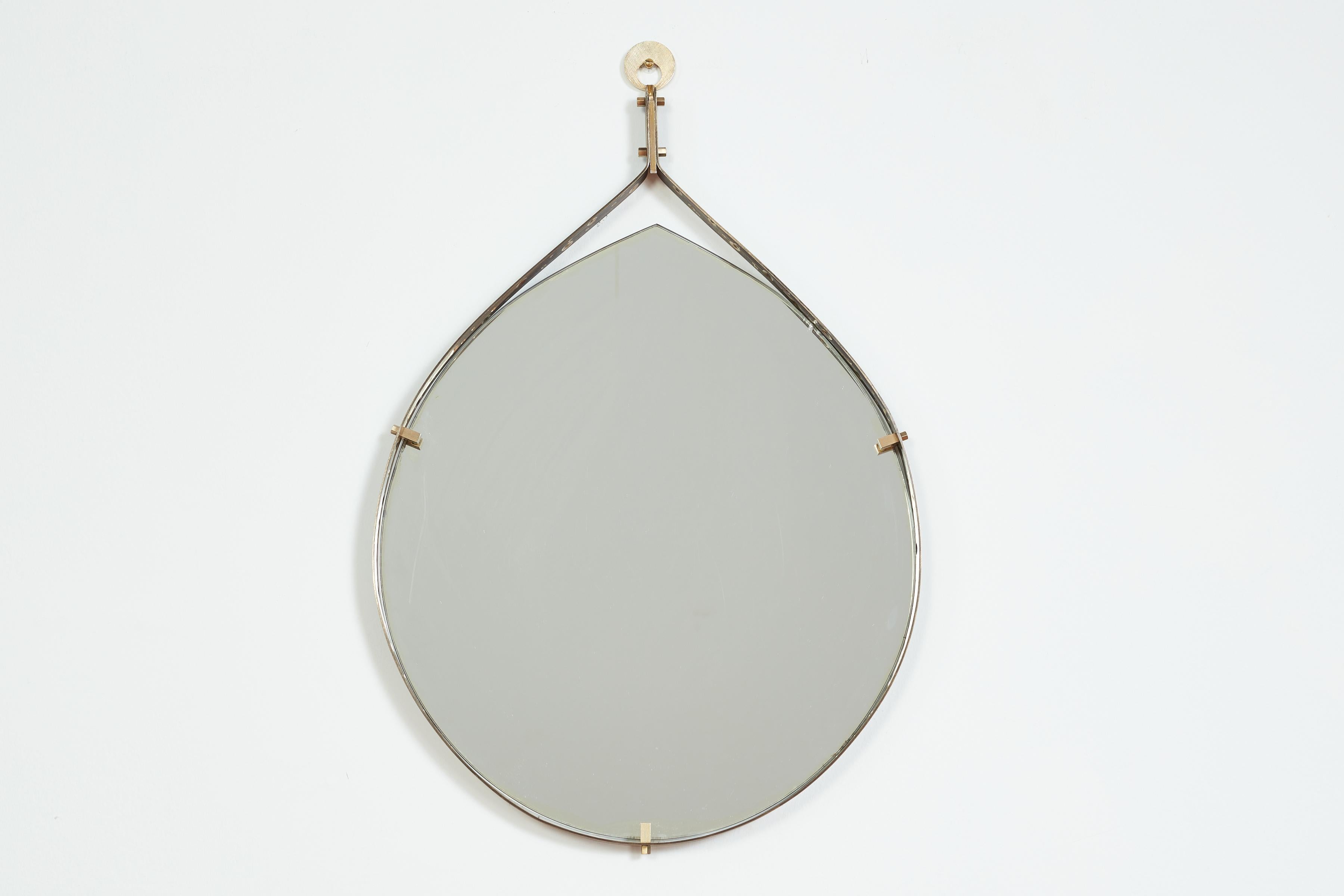1950's Italian silvered iron and brass tear dropped shaped mirror with perforated brass detail within the edge.  
Designed by Ambrogio  & De Berti - Italy, 1950s