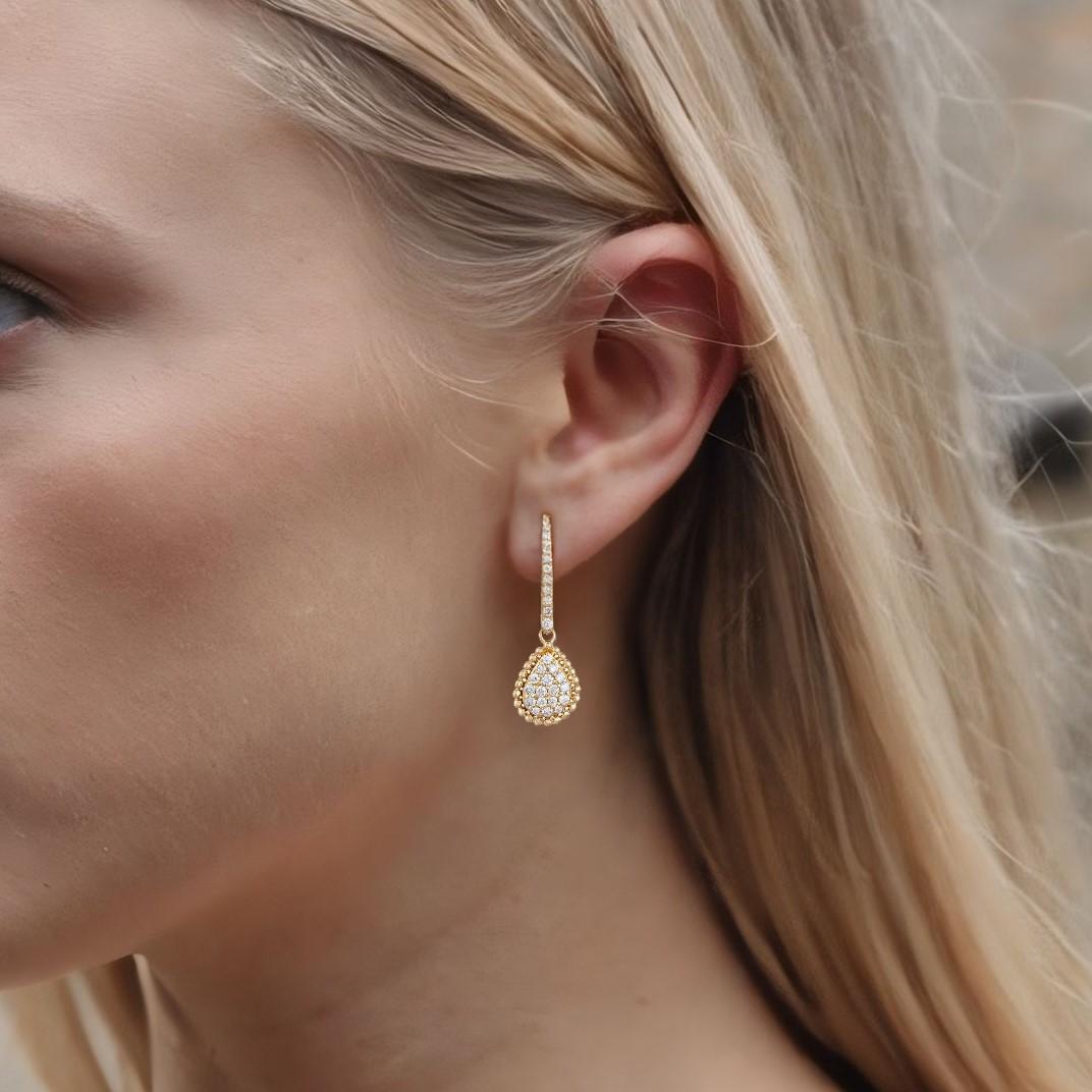 The Teardrop Pave Dangle 14K Yellow Gold Diamond Earrings feature brilliant natural diamonds set in 14K yellow gold, creating a striking yet refined design. The elegant drop style allows the diamonds to shine with every movement, offering a