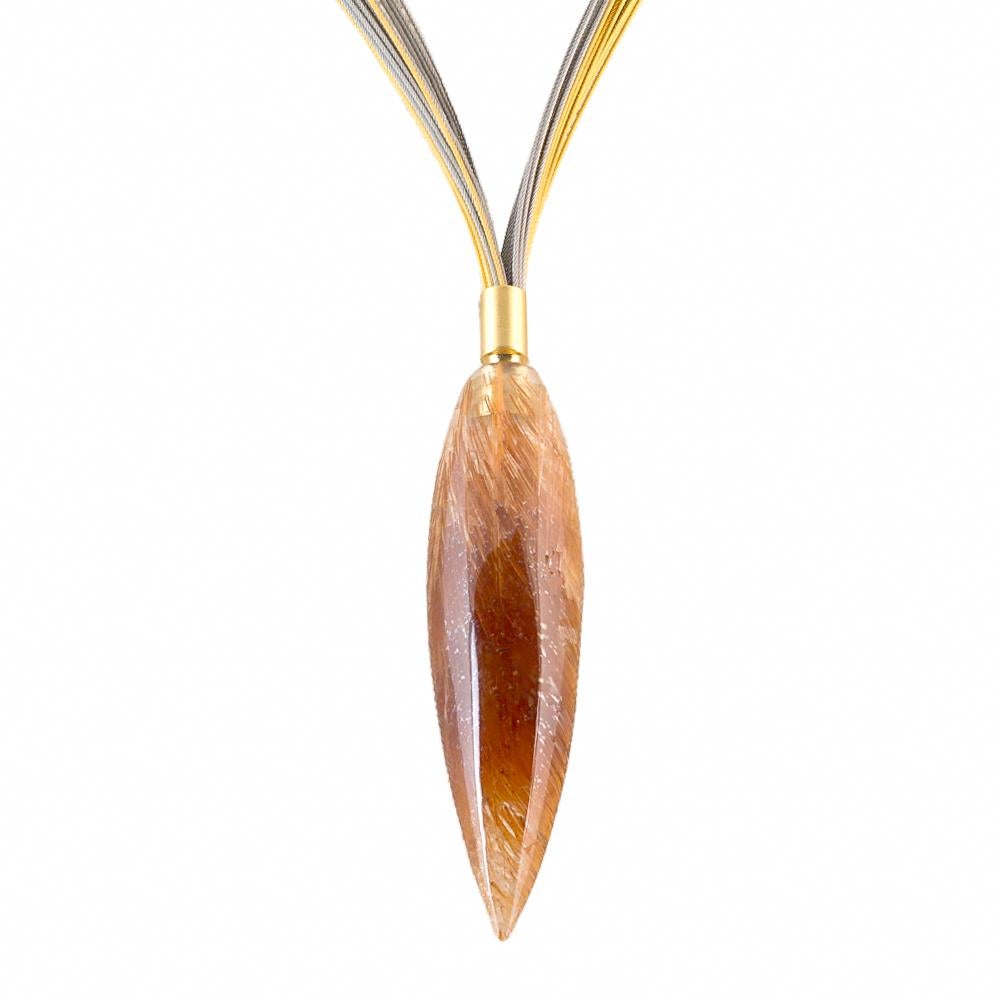 Rutilated Quartz teardrop pendant, with dense golden threading thoroughout the stone, hung on an 18 Karat  white and yellow gold multi cable necklace. 

The particular stone selected for this unique piece has an unusually attractive density and