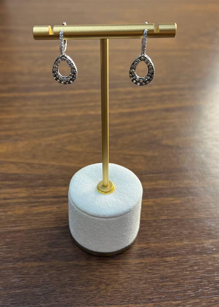 Elegant Dangle Drop Earrings. These exquisite earrings feature a delicate design with a circular drop encrusted with shimmering diamonds. The earrings are suspended from a sleek, polished hook, offering subtle movement and sparkle. Perfect for