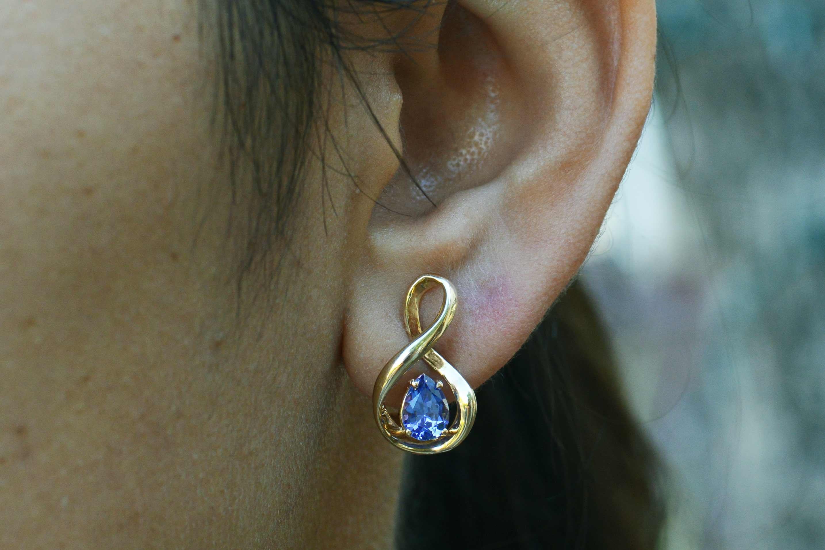 A pair of 1.20 carat diamond and tanzanite earrings with the most riveting violet hue. They're like staring into the beautiful eyes of Liz Taylor! The faceted oval gemstones topped with a cluster of captivating diamonds completes these modern estate