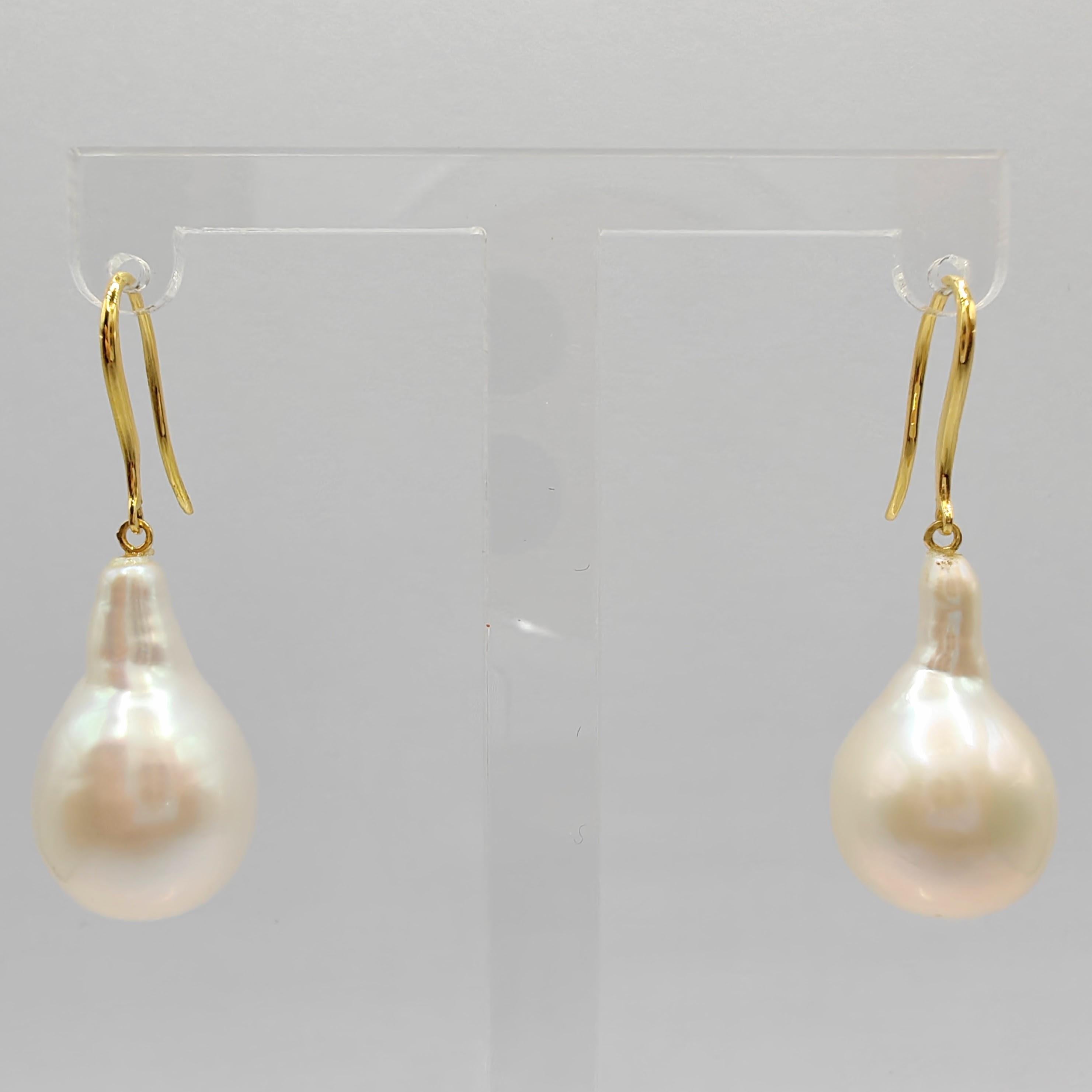 Indulge in the captivating allure of our Teardrop White Baroque Pearl Drop Earrings, meticulously crafted to inspire and captivate. These exquisite earrings showcase stunning Freshwater Cultured Baroque Pearls, boasting a brilliant white hue with a