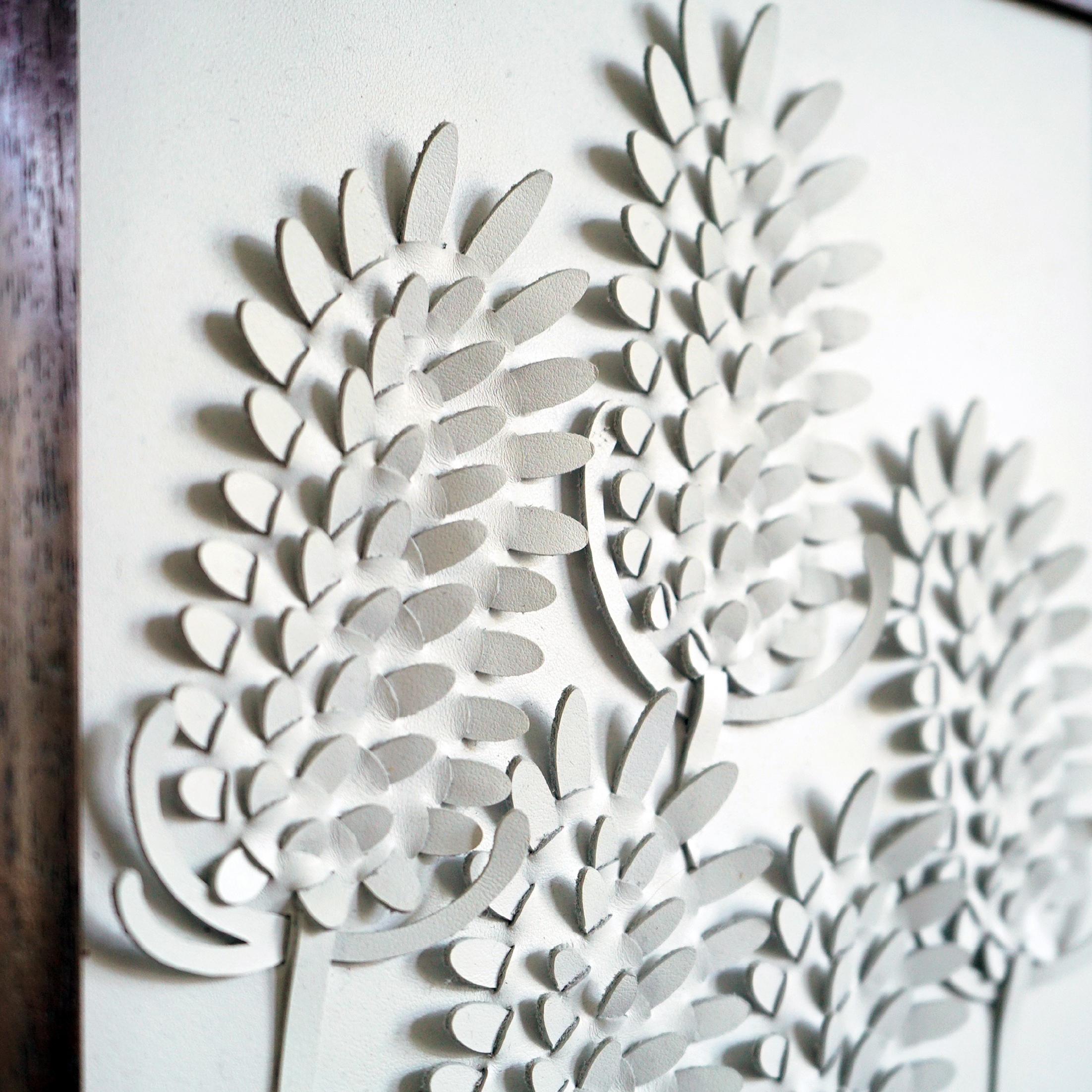 Teasel:

A piece of 3D sculptural wall art designed and made from two layers of white leather woven together by Louise Heighes.
Measurements are 11.6 x 14 inches or 29.5 x 35.5 cm

This piece is inspired by the distinctive shape of the Teasel with