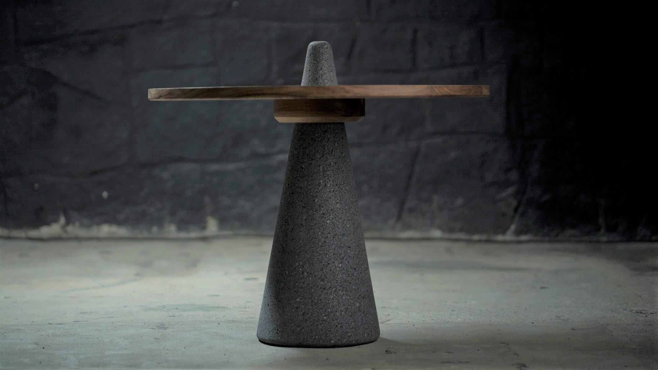 Teci table by Onora
Dimensions: D 60 x 60 cm
Materials: Carved basalt and thalami wood.

The Teci table was born from the synthesis of the stone metlapil used in the metate to grind corn. A tzalam wood surface rests on a conical basalt
