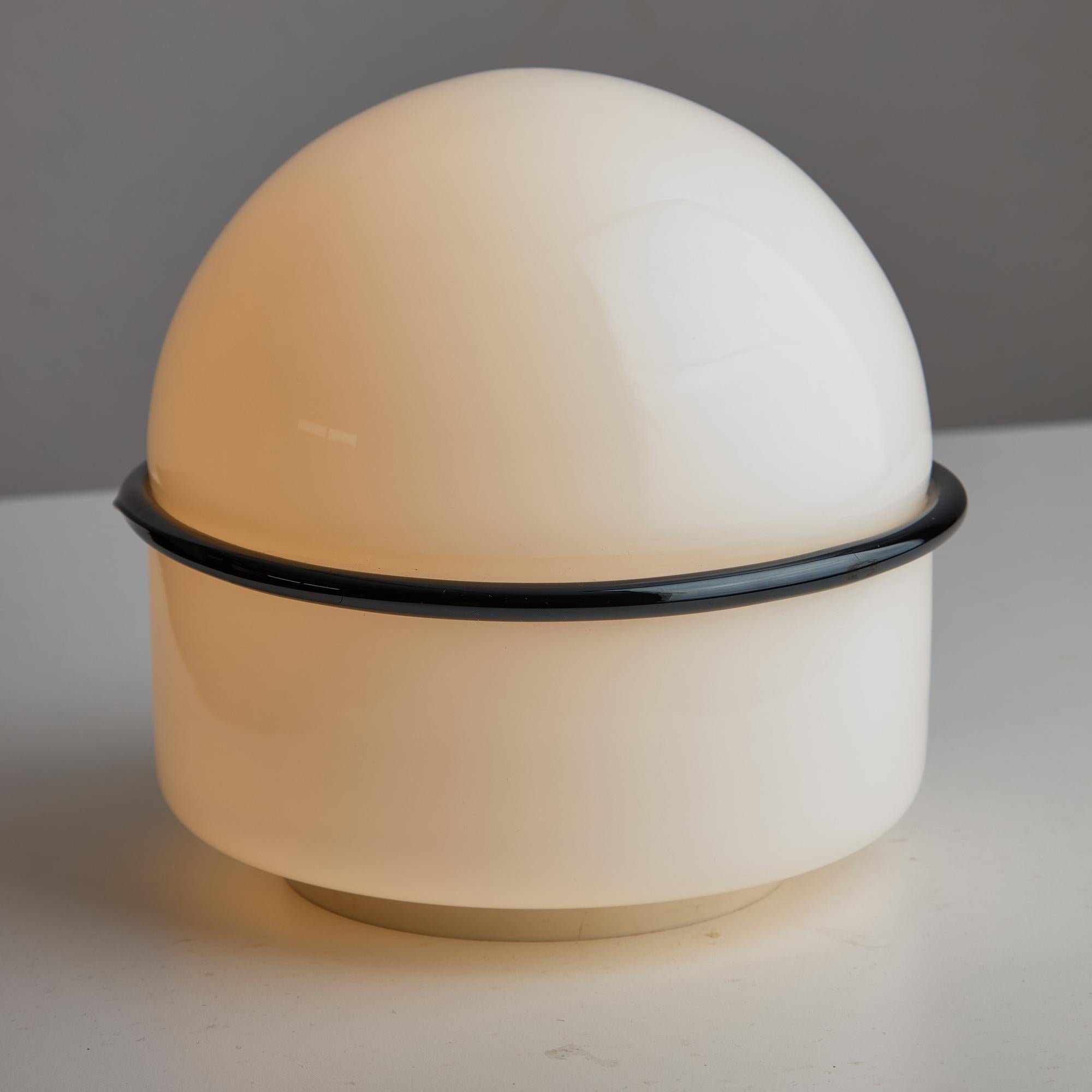 This 1960s Tecla Table Lamp, designed by Noti Massari for Leucos, is an iconic piece of mid-century modern lighting. Its design reflects the aesthetic sensibilities of the era, characterized by clean lines, organic forms, and innovative materials.
