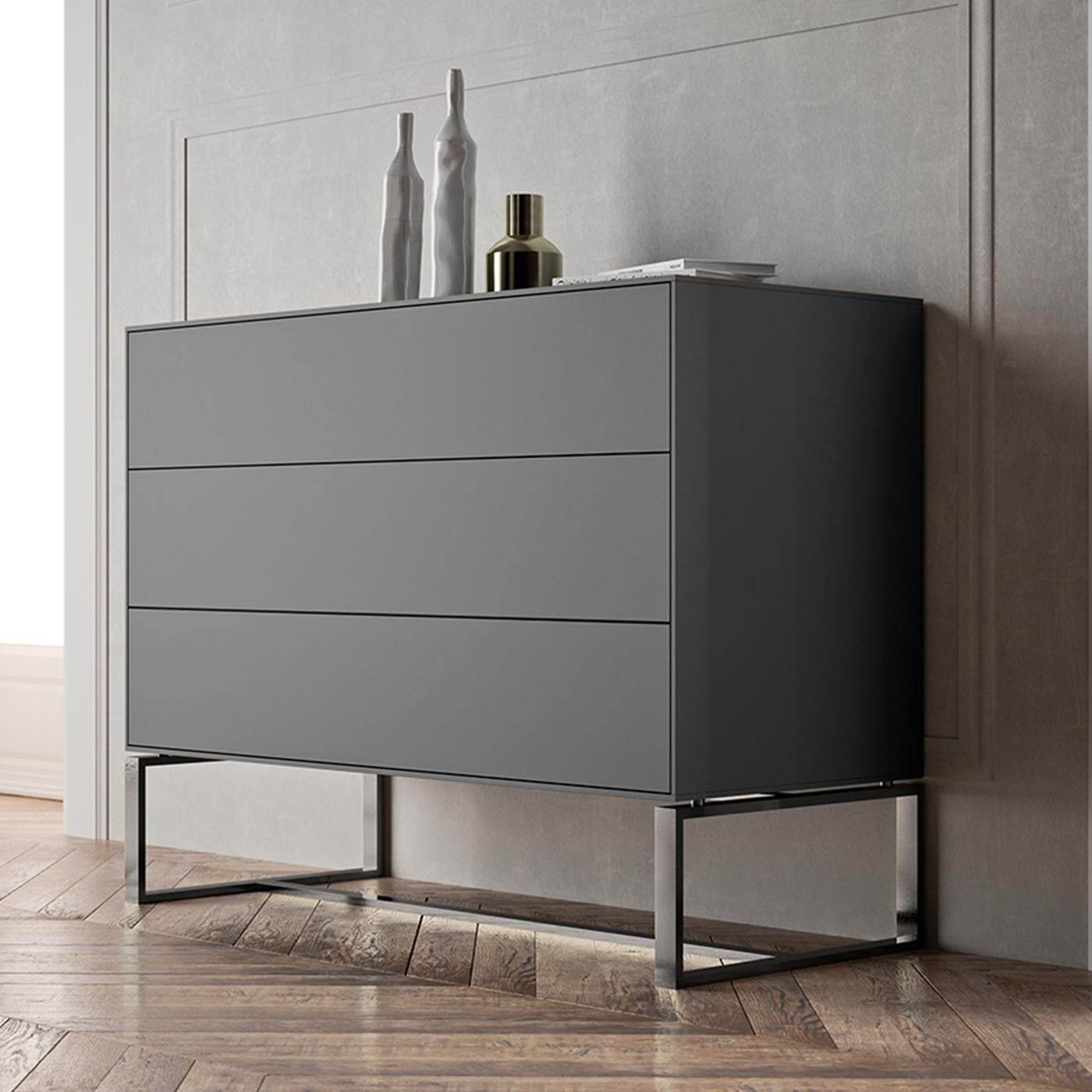 As suggested by its name, this dresser boasts a design that recalls the sleek aesthetic of modern technological innovations with its angular profile and cool color palette. The matte-gray lacquered MDF frame is supported by a streamlined iron base