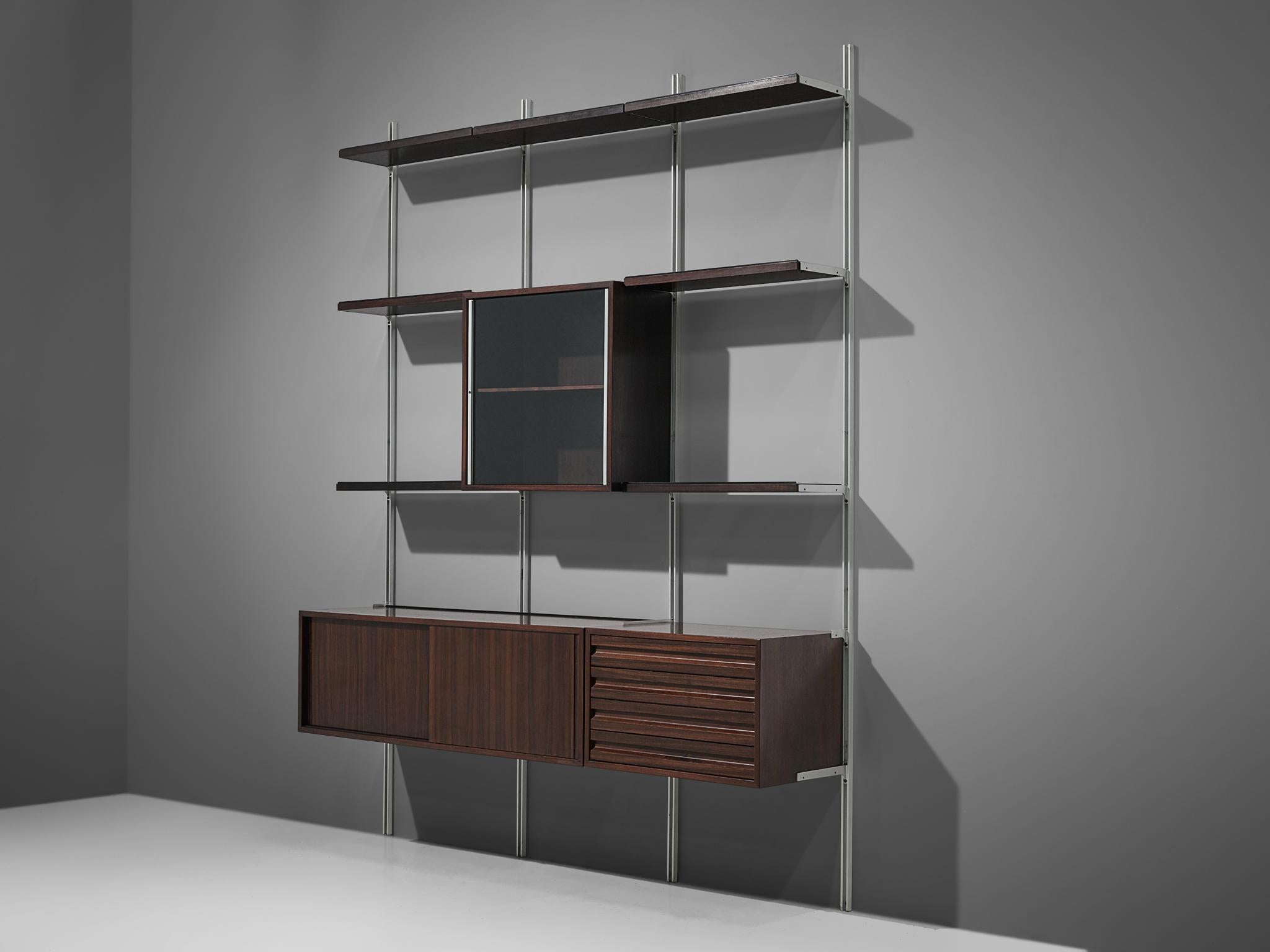 Osvaldo Borsani for Tecno, wall unit, metal and walnut, Italy, 1950s.

Modular shelving system designed by Osvaldo Borsani. The system was developed by Borsani as coordinated system for furnishing either the home or the office, the E22 is composed