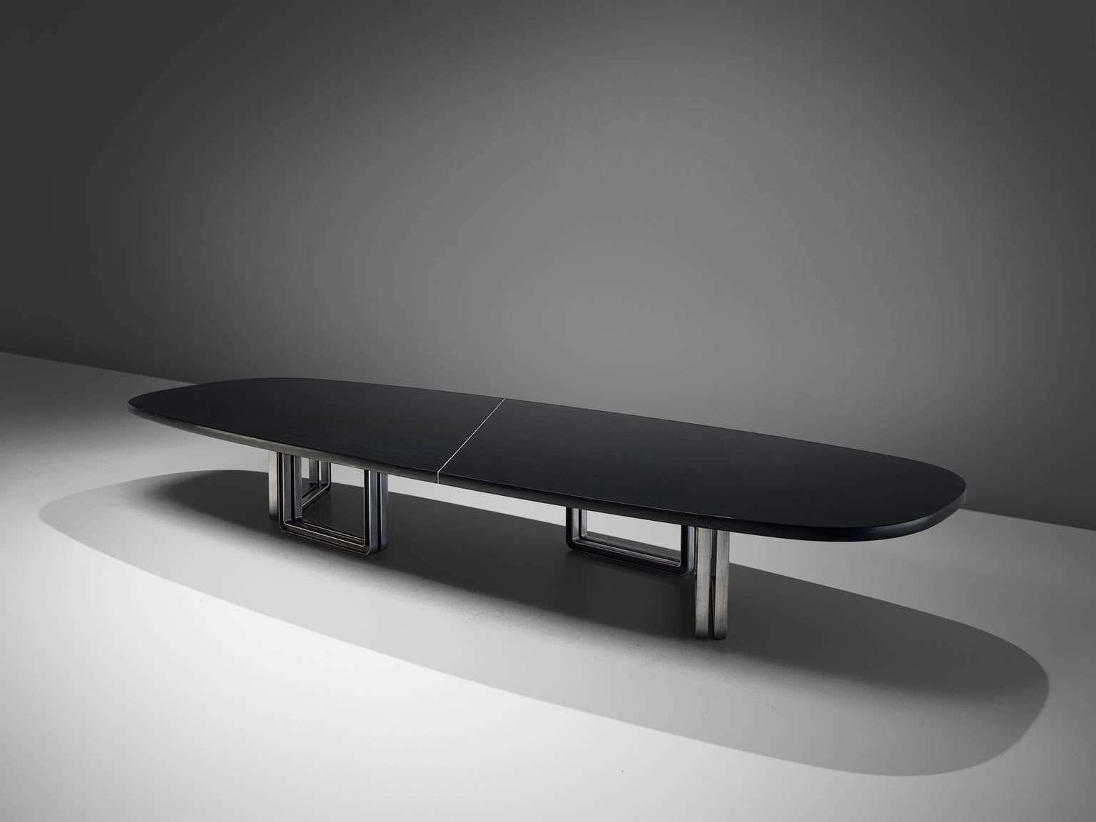 Tecno Design Centre for Tecno, lacquered black wood and aluminum base, conference table 335a, Italy, 1975-1978.

Large oversized conference table with a black top. The table is composed of two black pieces connected via steel inserts and mounted