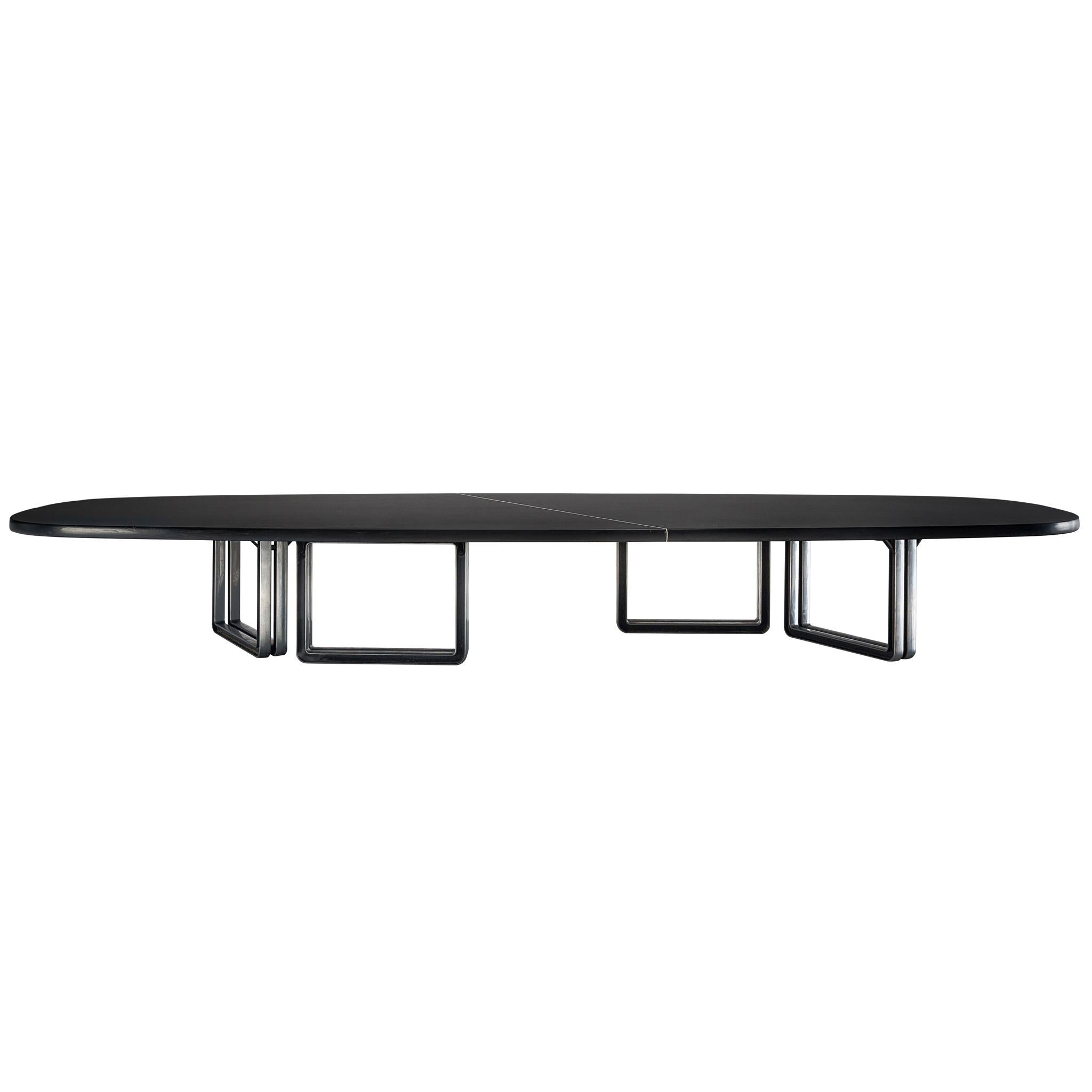 Tecno Design Centre for Tecno, lacquered black wood and aluminum base, conference table 335a, Italy, 1975-1978.

Large oversized conference table with a black top. The table is composed of two black pieces connected via steel inserts and mounted
