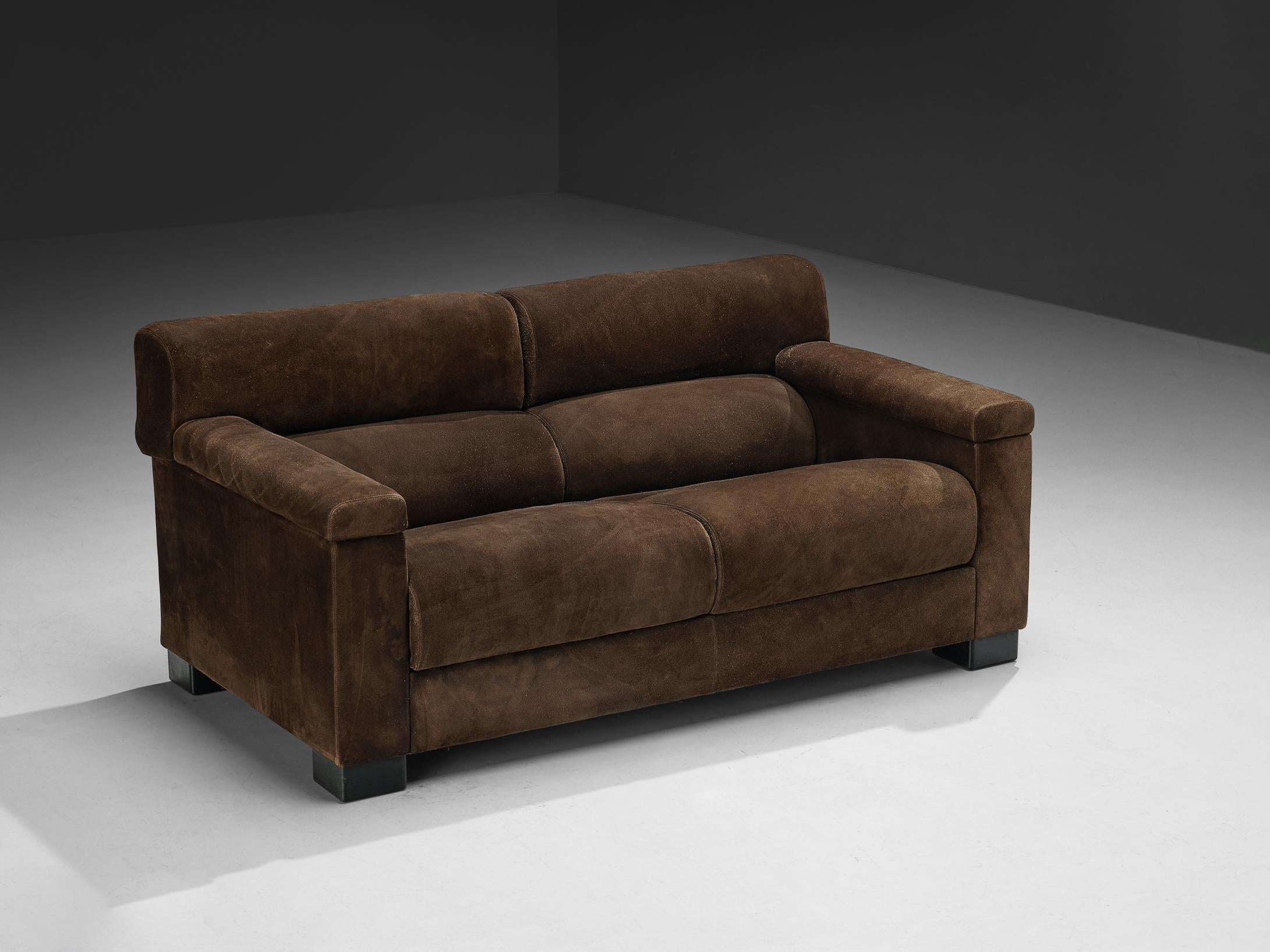 Tecno, sofa, suede, dark stained wood, Italy, 1960s. 

A substantial and sizable sofa produced by Italian furniture company Tecno. The bulky appearance is amplified by the upholstery, which features a dark brown suede upholstery. The sofas deep seat