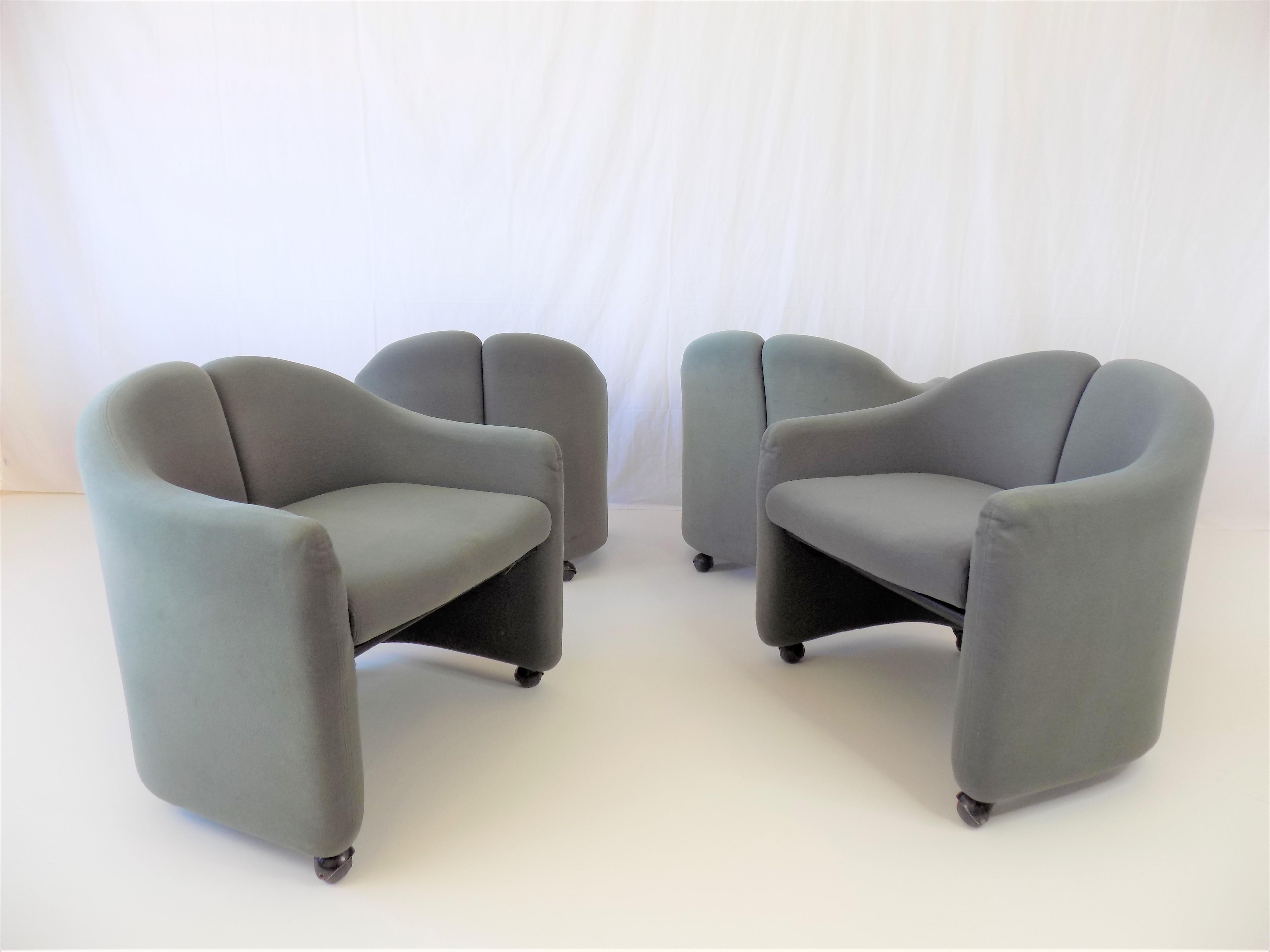 This set of 4 PS 142 lounge chairs comes in a blue gray velvet fabric and is in very good condition.  The soft fabric shows minimal signs of use on all armchairs. The suspension is firm and offers good seating comfort. The castors on the armchairs