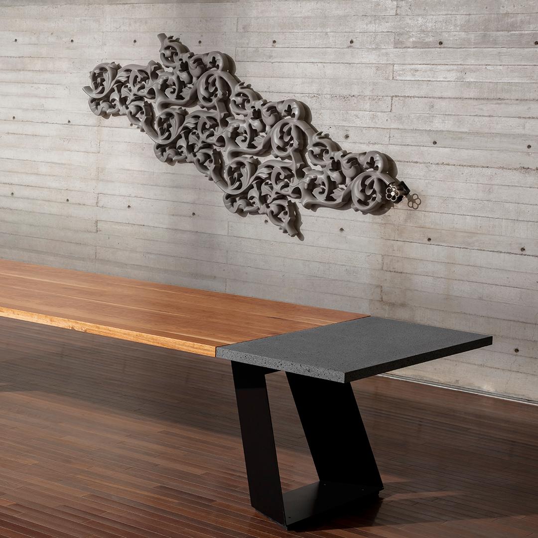 The design of the dining table that incorporates wood, lava stone, and steel in a contemporary style focuses on merging natural and modern elements to create a visually appealing and functional piece.

The table's surface is crafted from