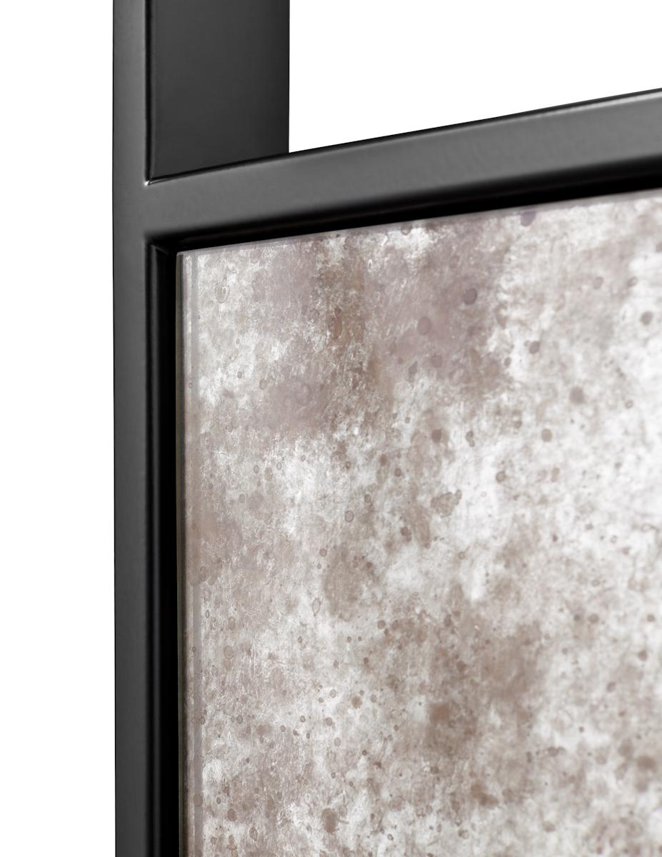 Random cut mirror panels of varying thickness, inset into metal frame topped with bold metal mounting bracket.

Shown with mercury mirror and satin black frame. 

Available in clear, mercury or antique mirror. 

Metal finishes available in a