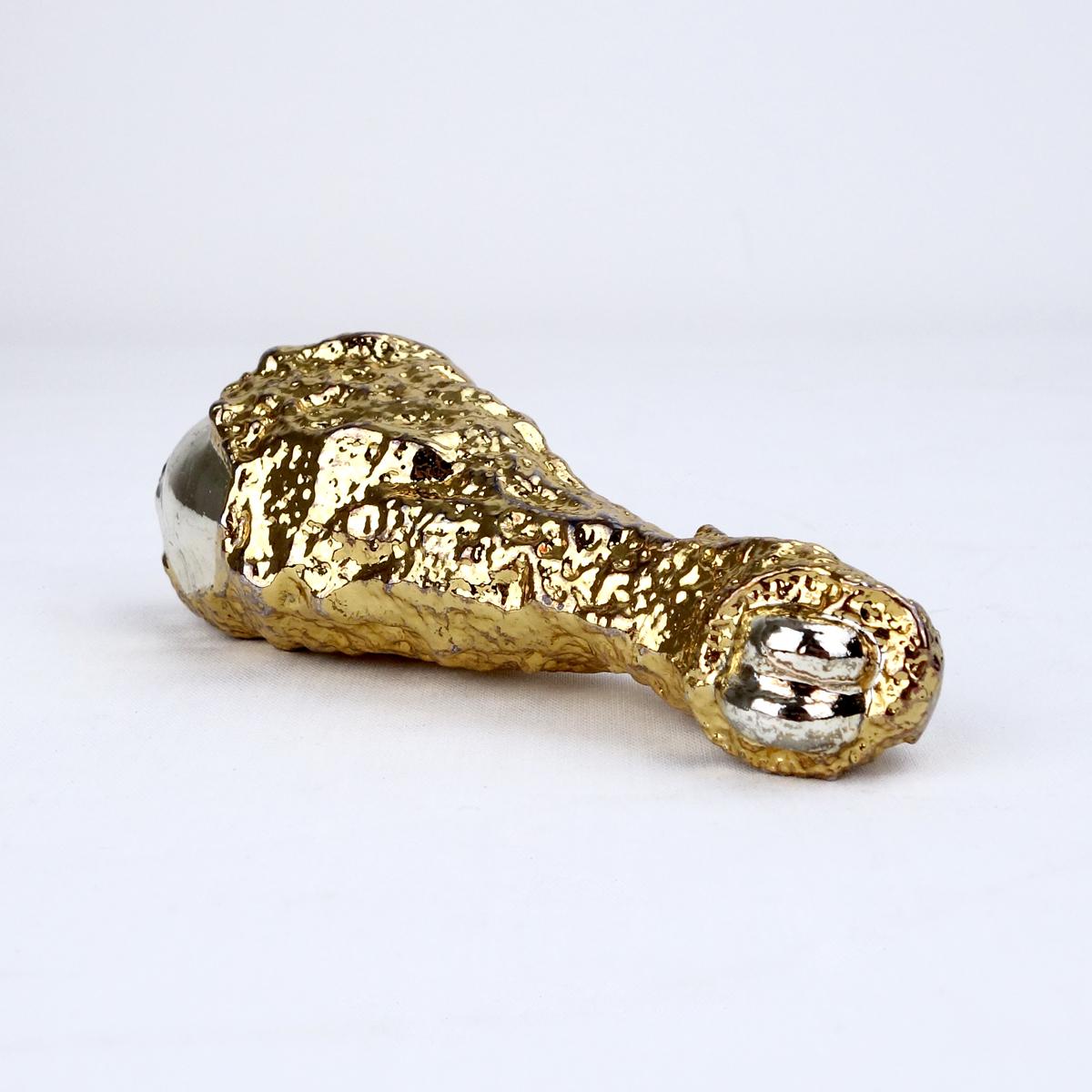 Ted Arnold high society solid fake gold cast fast food emporium says the original carton box. According to the same box the series contained this golden fried chicken leg, a golden fried egg, a hand cast ice cream cone, a gold burger, a mushroom