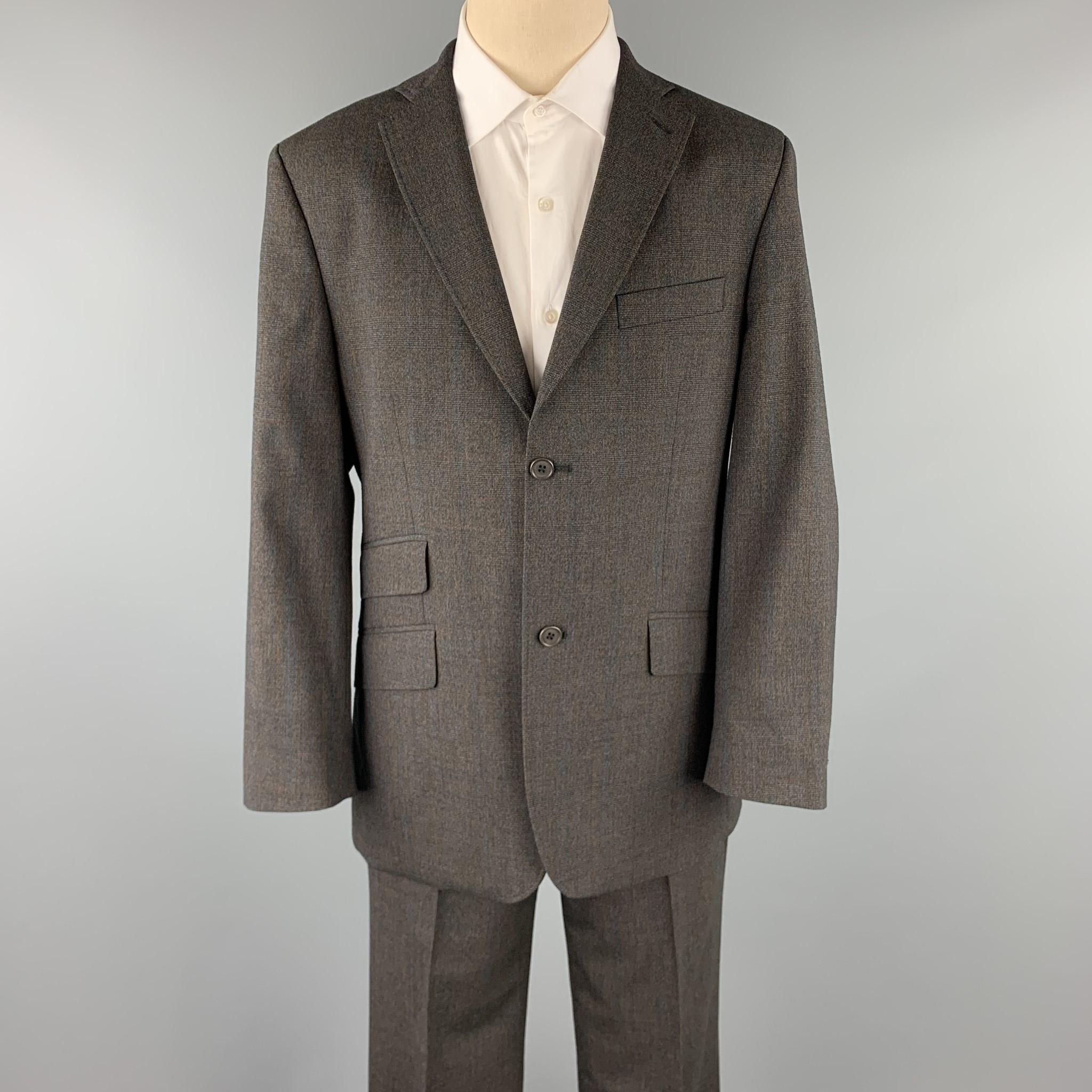 TED BAKER suit comes in a charcoal glenplaid wool with a full purple iridescent liner and includes a single breasted, two button sport coat with a notch lapel and matching flat front trousers. 

Excellent Pre-Owned Condition.
Marked: 40