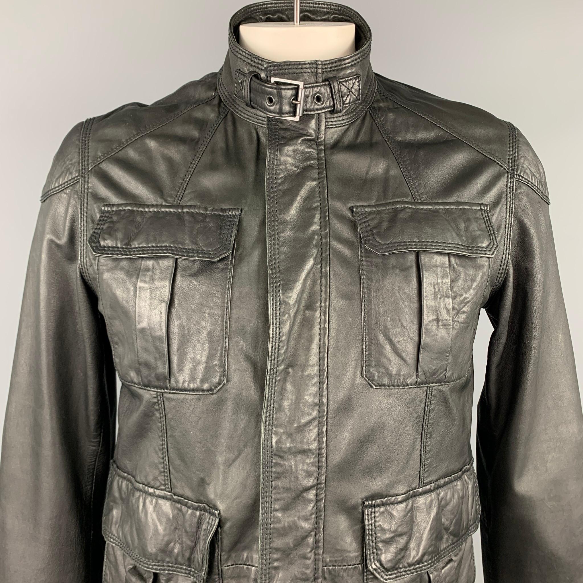 TED BAKER jacket comes in a black leather with a full liner featuring a belted strap collar, patch pockets, and a zip & snap button closure.

Very Good Pre-Owned Condition.
Marked: 4

Measurements:

Shoulder: 18 in.
Chest: 42 in.
Sleeve: 27.5