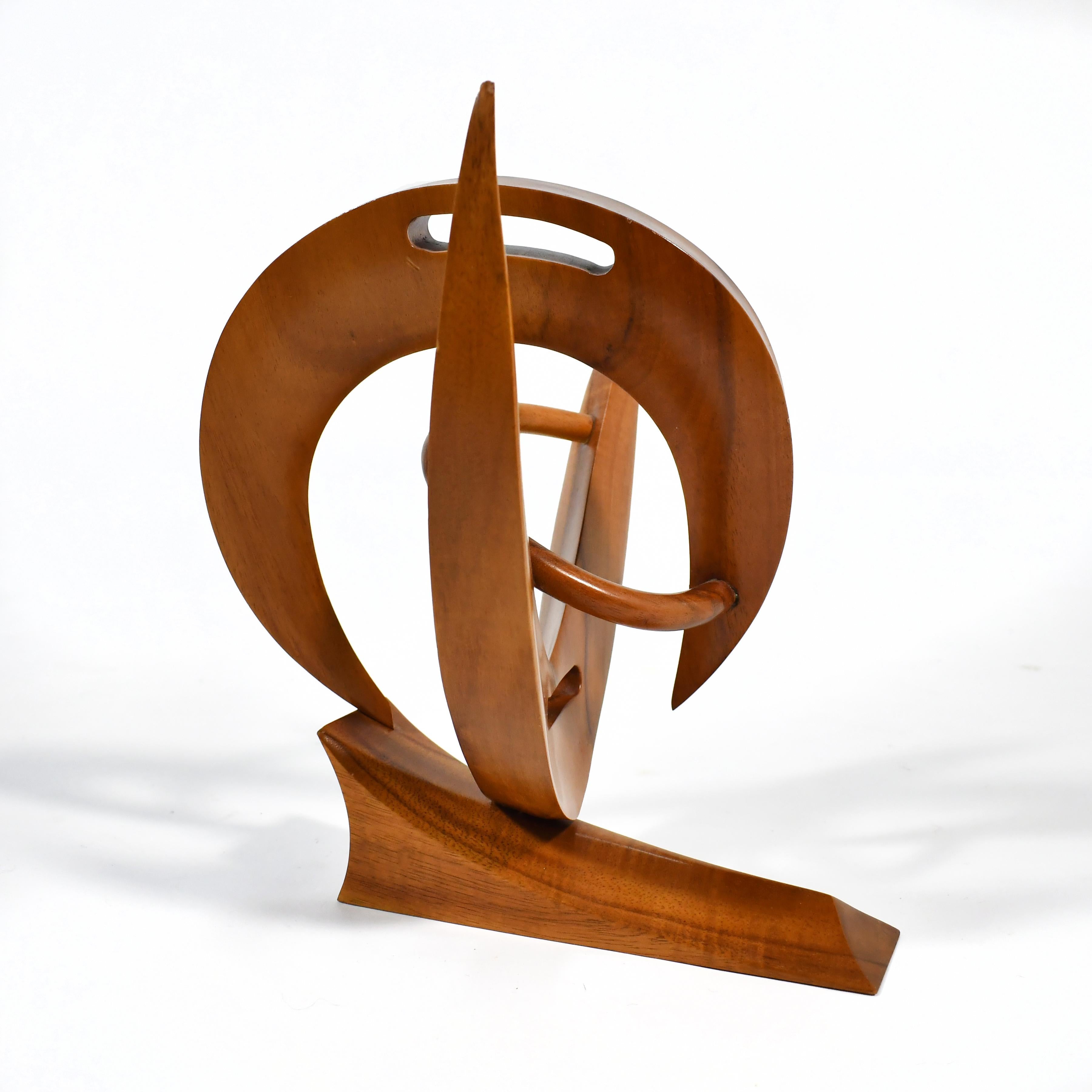 This dynamic sculpture features shapes that curve, sweep, touch and seperate accentuating both positive and negative space. California sculptor Ted L. Jacox was known for wood pieces in both representational and abstract forms. This example in