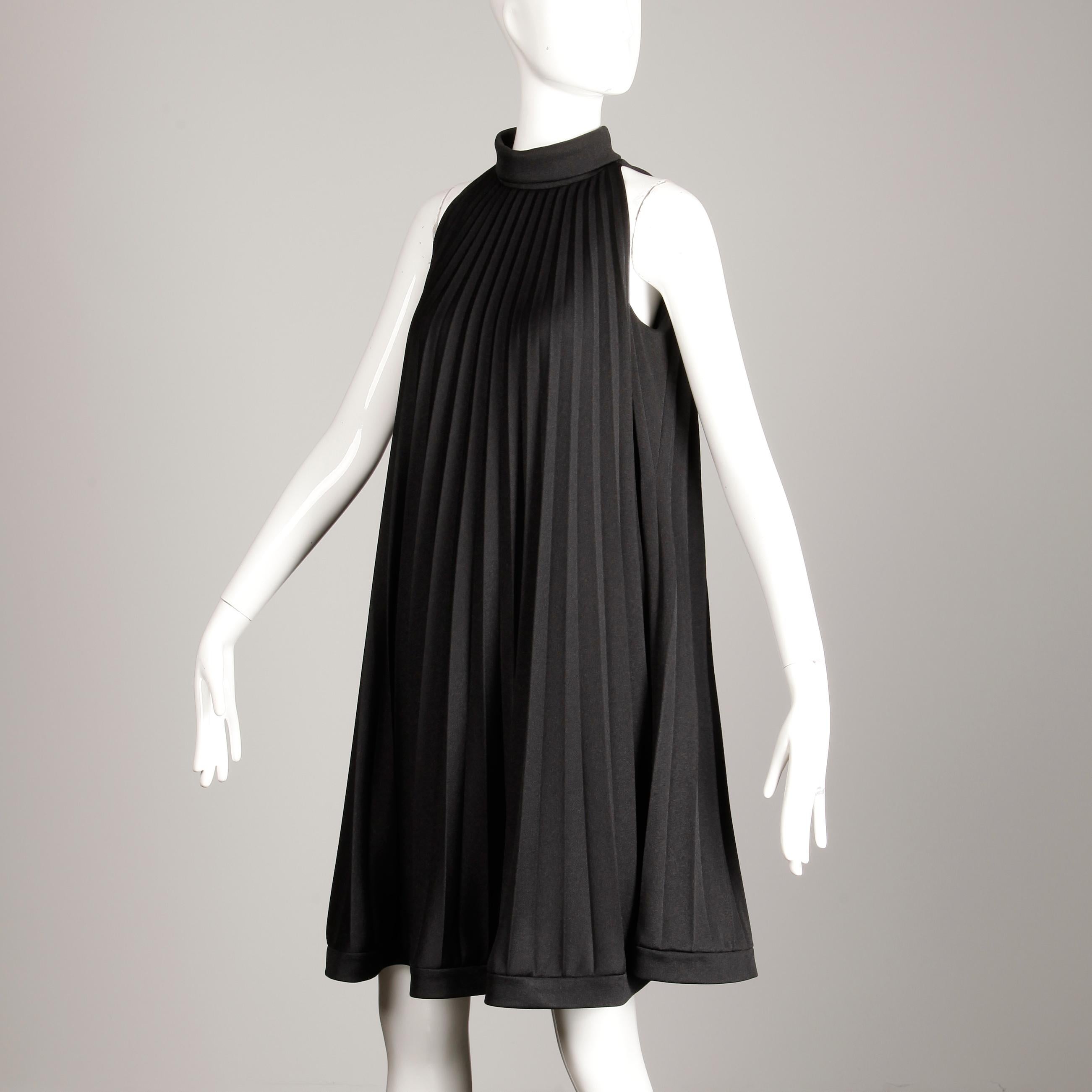So mod! Vintage 1960s pleated A-line trapeze dress by Ted Lapidus. Fully lined with rear zip and hook closure. 100% medium weight polyester. The marked size is 38/12, but the dress fits more like a modern small-medium. The bust measures 37.5
