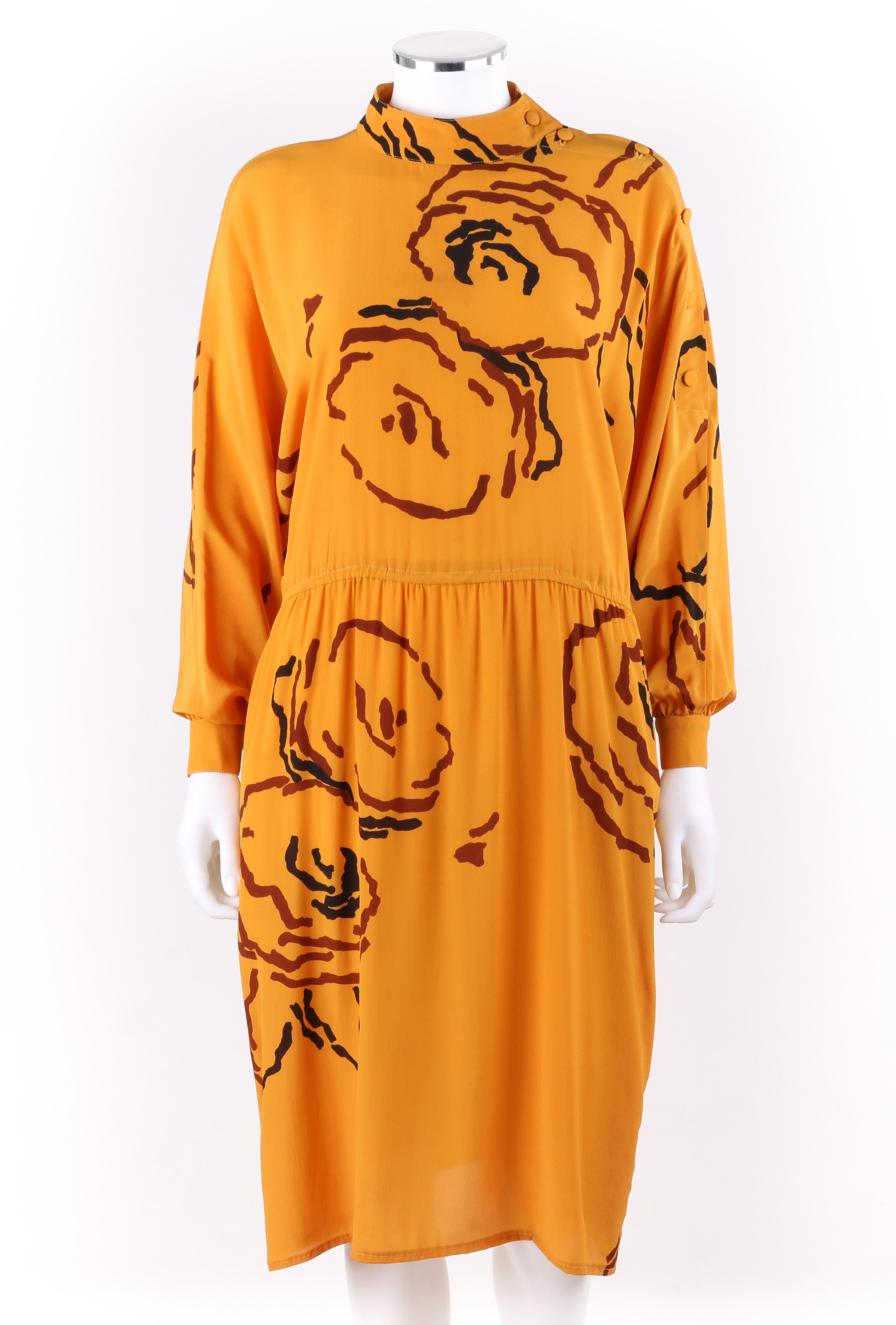 Vtg. TED LAPIDUS c.1980’s Saffron Orange Peony Floral Silk Long Sleeve Dress & Belt
 
Circa: 1980’s
Label(s): Ted Lapidus 
Style: Elasticized waist dress
Color(s): Shades of orange, brown and black 
Lined: No
Marked Fabric Content: 68% Acetate, 32%