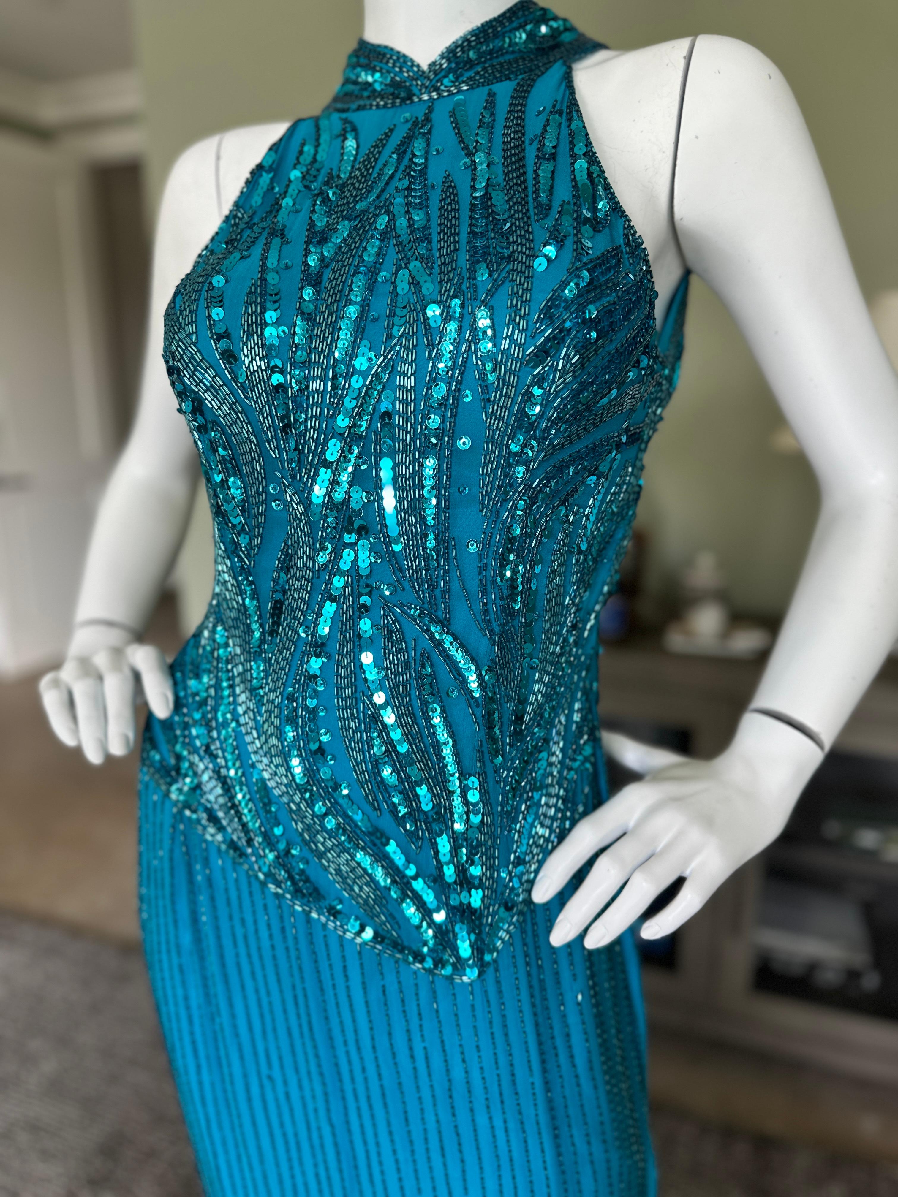 Ted Lapidus Paris 1970's Beaded Sequin Halter Evening Dress.
This is so pretty, reminds me of Mackie in technique.
The neck is very small, I couldn't  fasten in on my mannequin.
Size Small or X Small
Bust 34