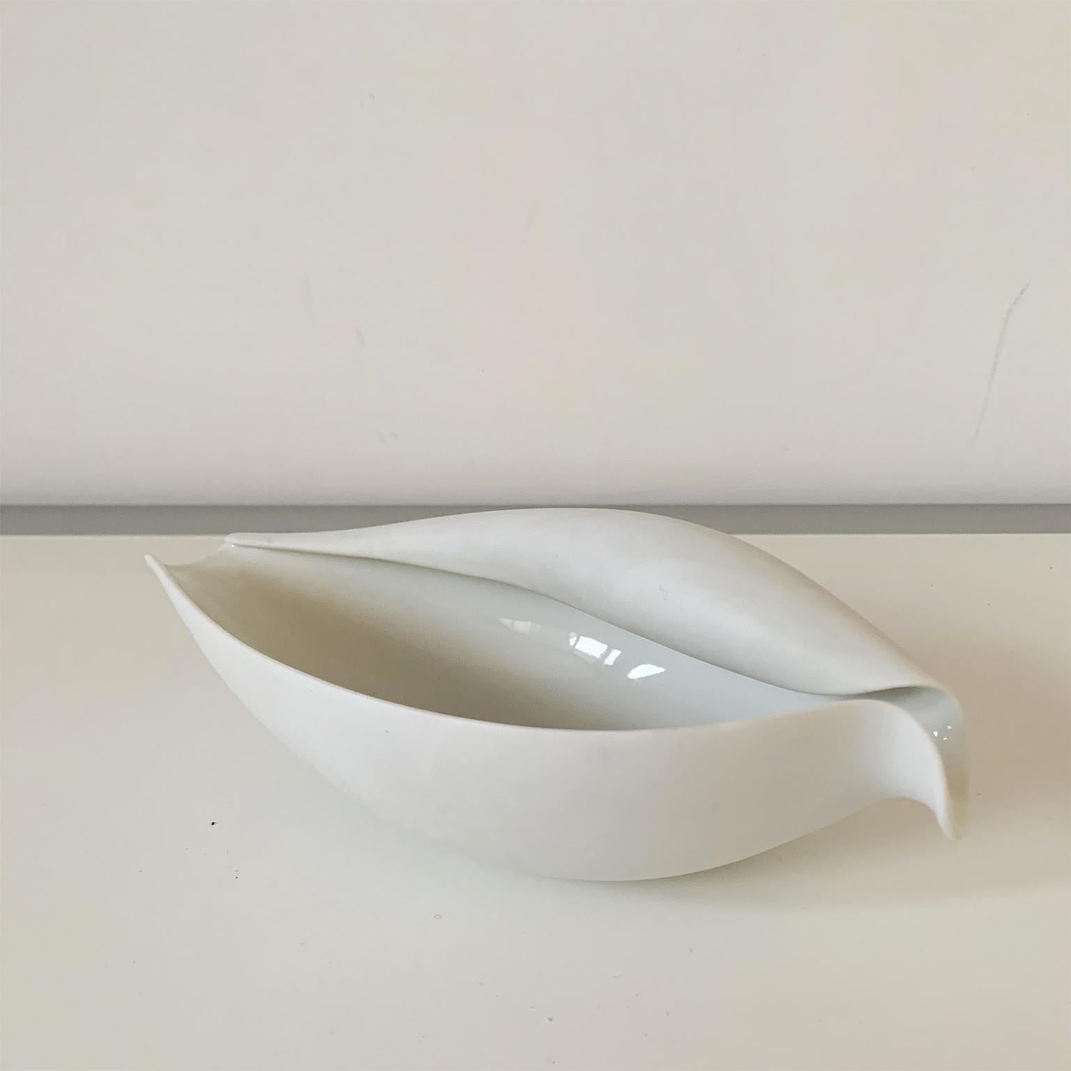 Ted Muehling for Nymphenburg porcelain volute bowl. The bowl features a white bisque exterior & glazed interior. 
It measures approximately 7 1/2? x 4? & 2 1/2