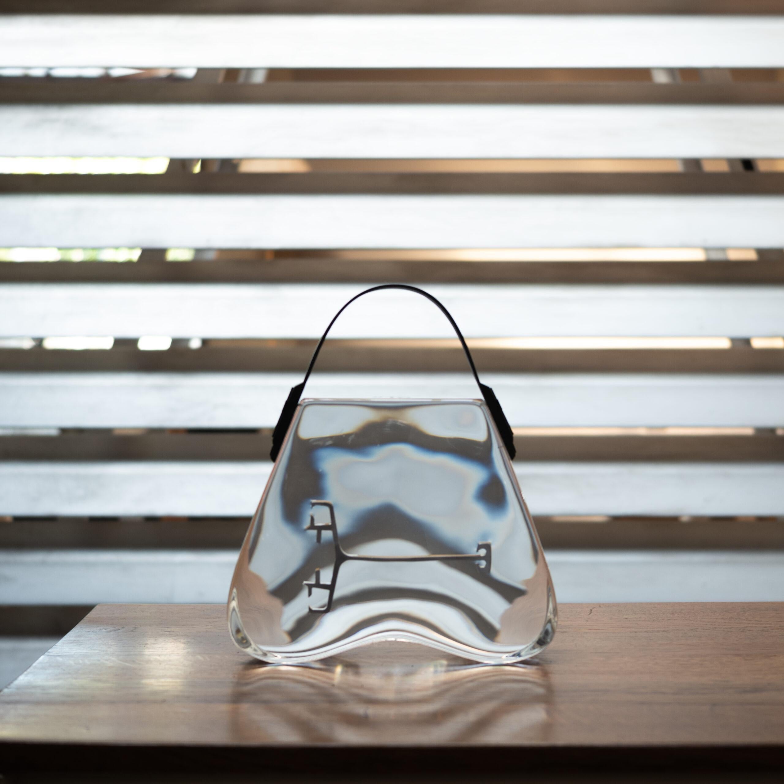 Ted Norton's work is based on a unique approach and profound concepts. He is particularly known for a series of handbag-shaped pieces, in which he encapsulates jewelry, small items, and even fish in stunningly clear resin. His 