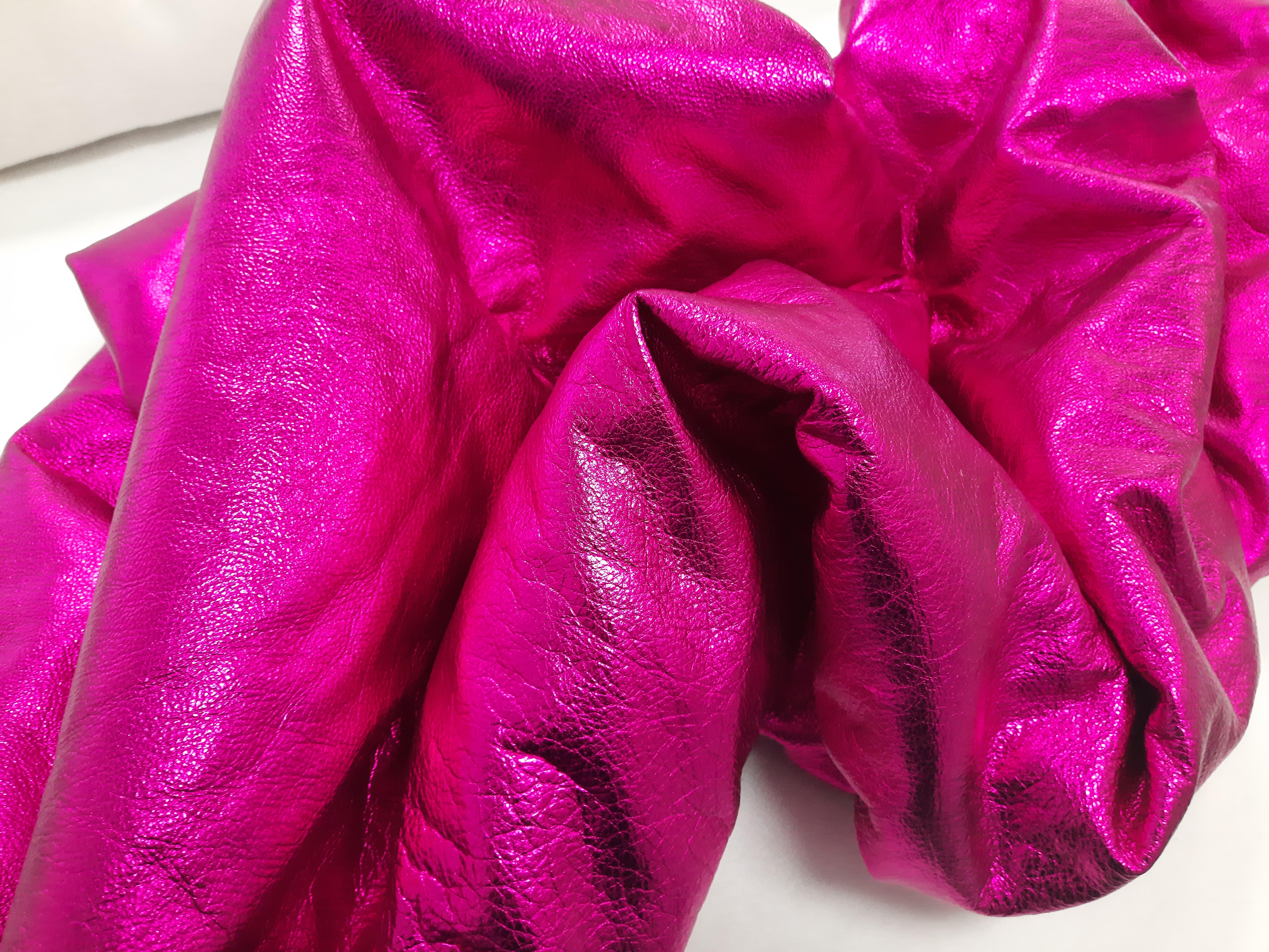 Drape in Deep Pink by Ted VanCleave transforms a single sheet of metallic leather into a sinuous, process-driven study of material and form. Its creased, crinkled, and softly wrinkled surface catches the light with a vivid electric blue sheen—slick,