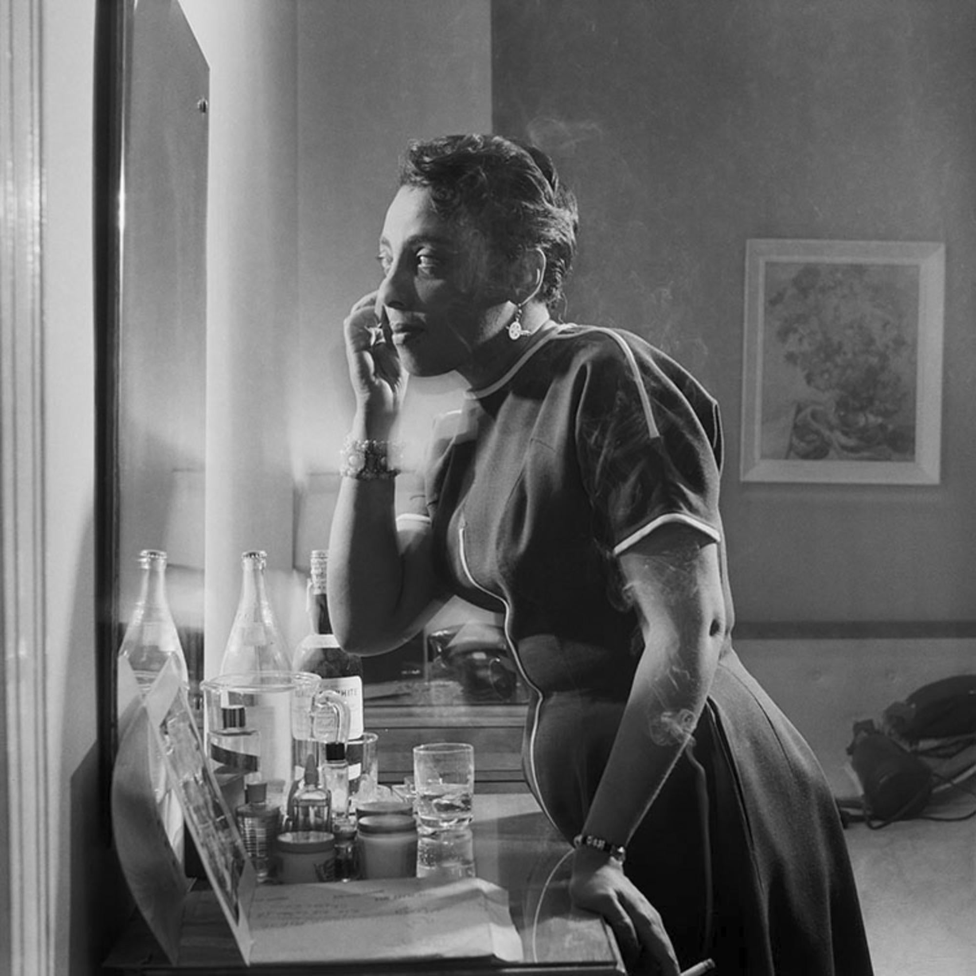 Estate-stamped, gelatin-print silver

American jazz singer Carmen McRae smoking and applying make-up in her Chicago Hotel Room, 1956.

Available sizes: 
16”x20" Edition of 25
20”x24" Edition of 25
30”x40" Edition of 25
40”x60” Edition of 25

This