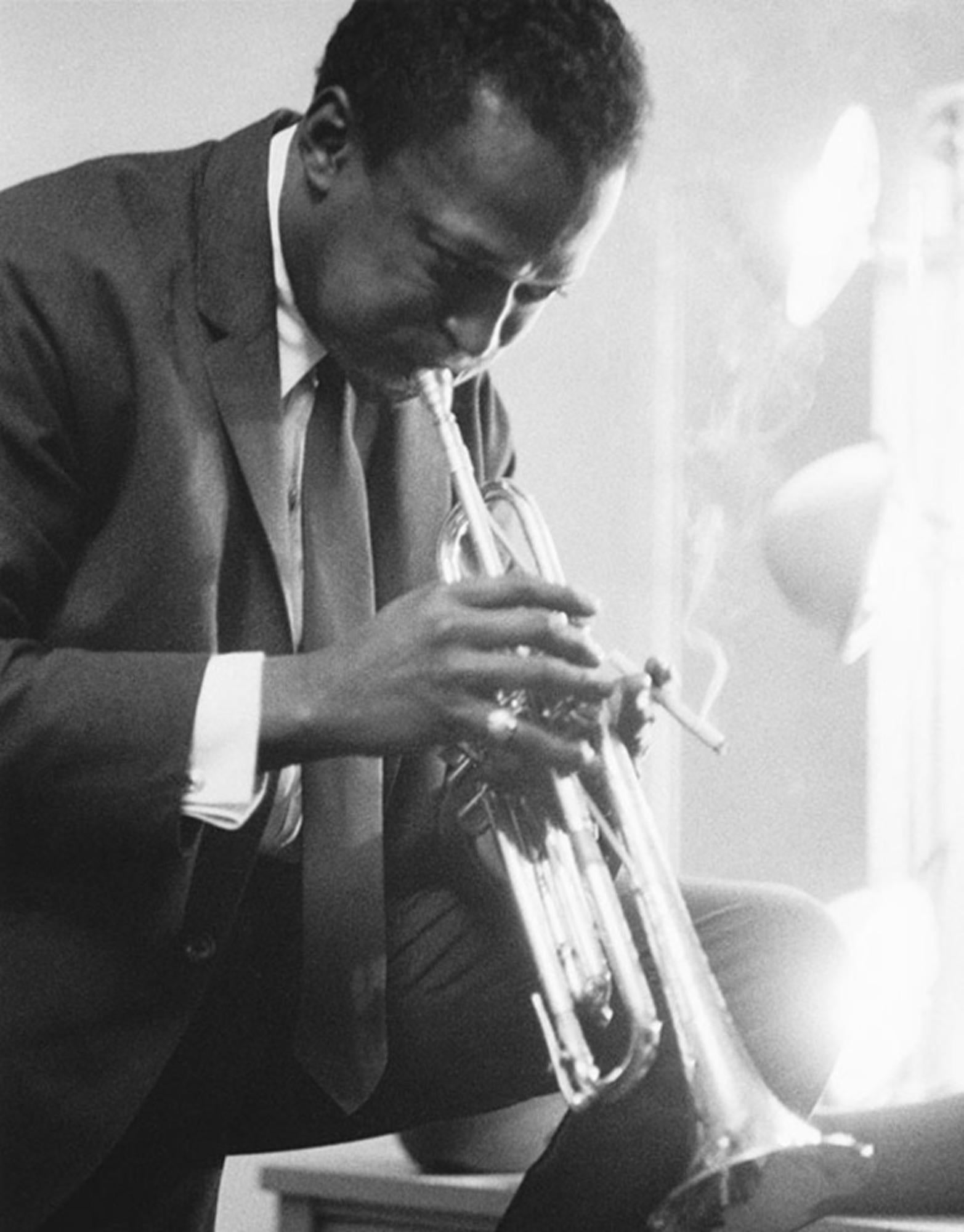 Estate-stamped, gelatin-print silver

American jazz musician, bandleader and composer Miles Davis playing the trumpet in a dressing room before a performance.

Available sizes: 
20”x16" Edition of 25
24”x20" Edition of 25
40”x30" Edition of
