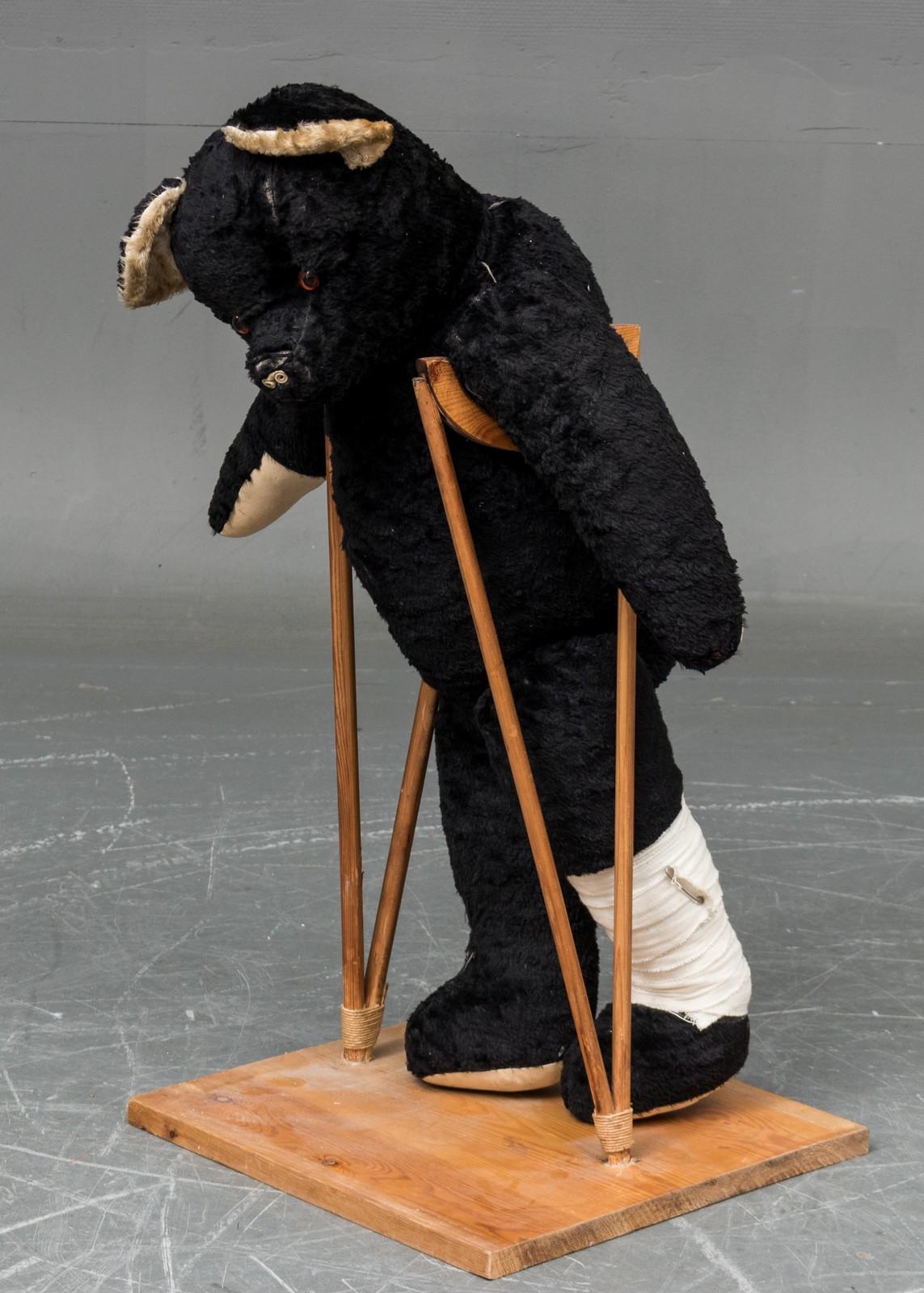 Teddy bear on crutches, ant. 1930. Nose wear and minor hole at one foot.