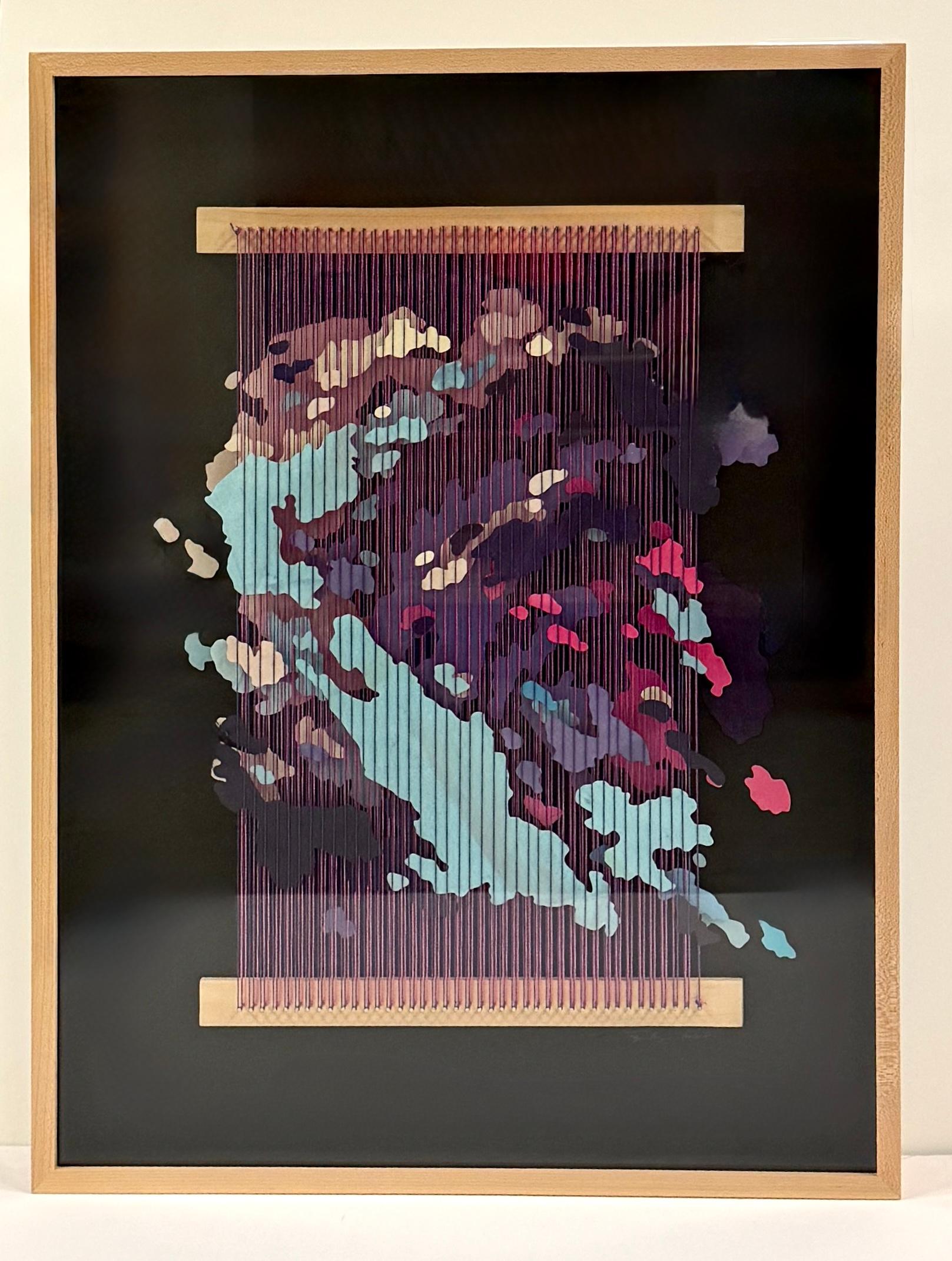 Tegan Brozyna Roberts weaves painted hand cut paper in between two layers of different color threads in abstract map-like formations. The paper pieces are seemingly suspended in this 3-d artwork. This work comes framed in a 2.75