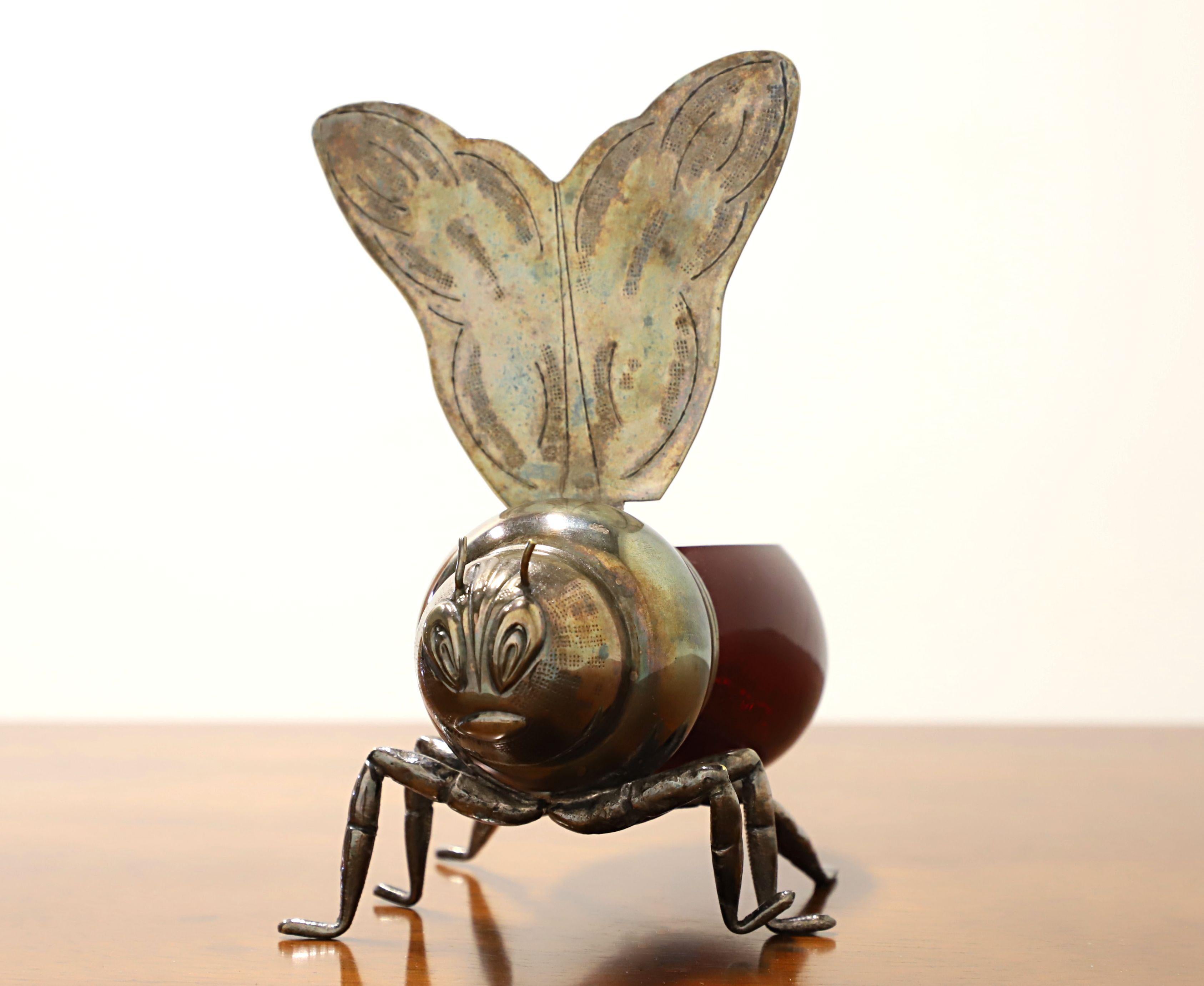 A stylish and cute honey pot by the Florentine silversmiths Teghini Firenze. Shaped like a large honey bee with silver plated head, legs & wings, and the body being made from blown glass in a ruby red shade. Features a hinged lid in the shape of