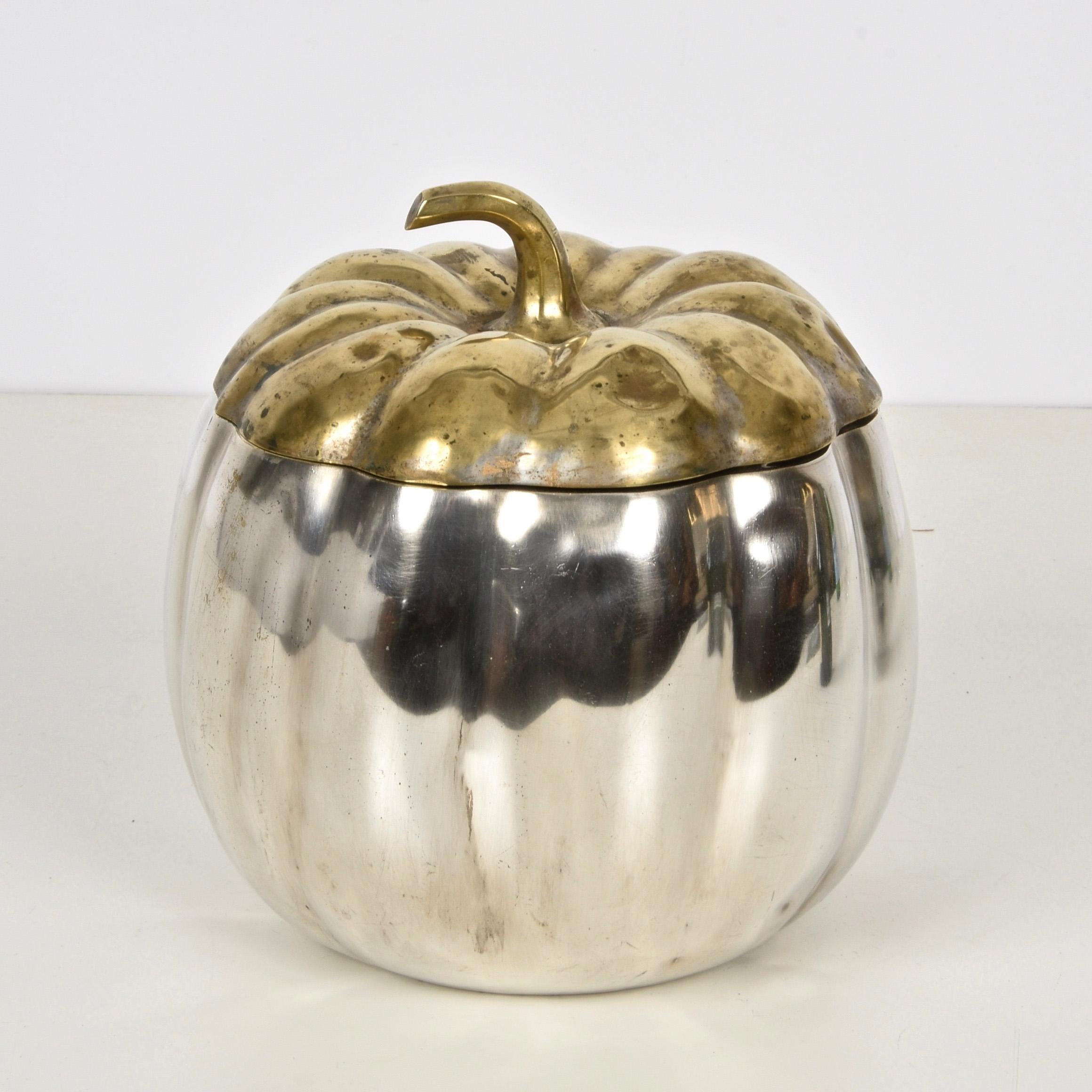 Wonderful midcentury pumpkin-shaped ice bucket in silver plate and brass. This fantastic item was made in Florence, Italy, during the 1960s by Teghini Firenze.

The piece is unique as it is shaped like a pumpkin and has two pieces, the top can be