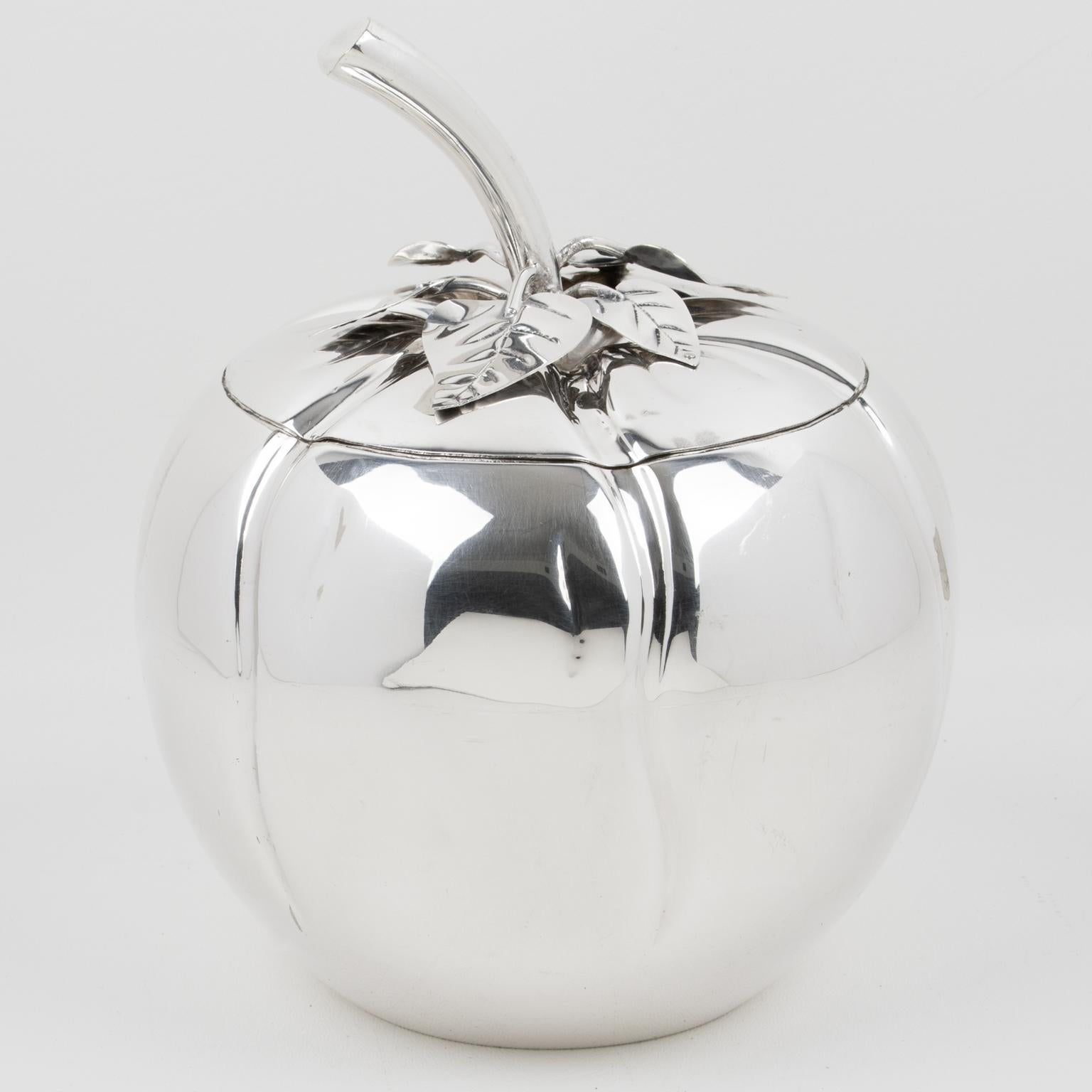 Teghini Firenze designed this lovely modernist silver plate ice bucket in the 1980s. The piece features a rounded shape with an oversized stylized tomato design with a lid and a strainer insert. There is no visible maker's mark.
The ice bucket is in