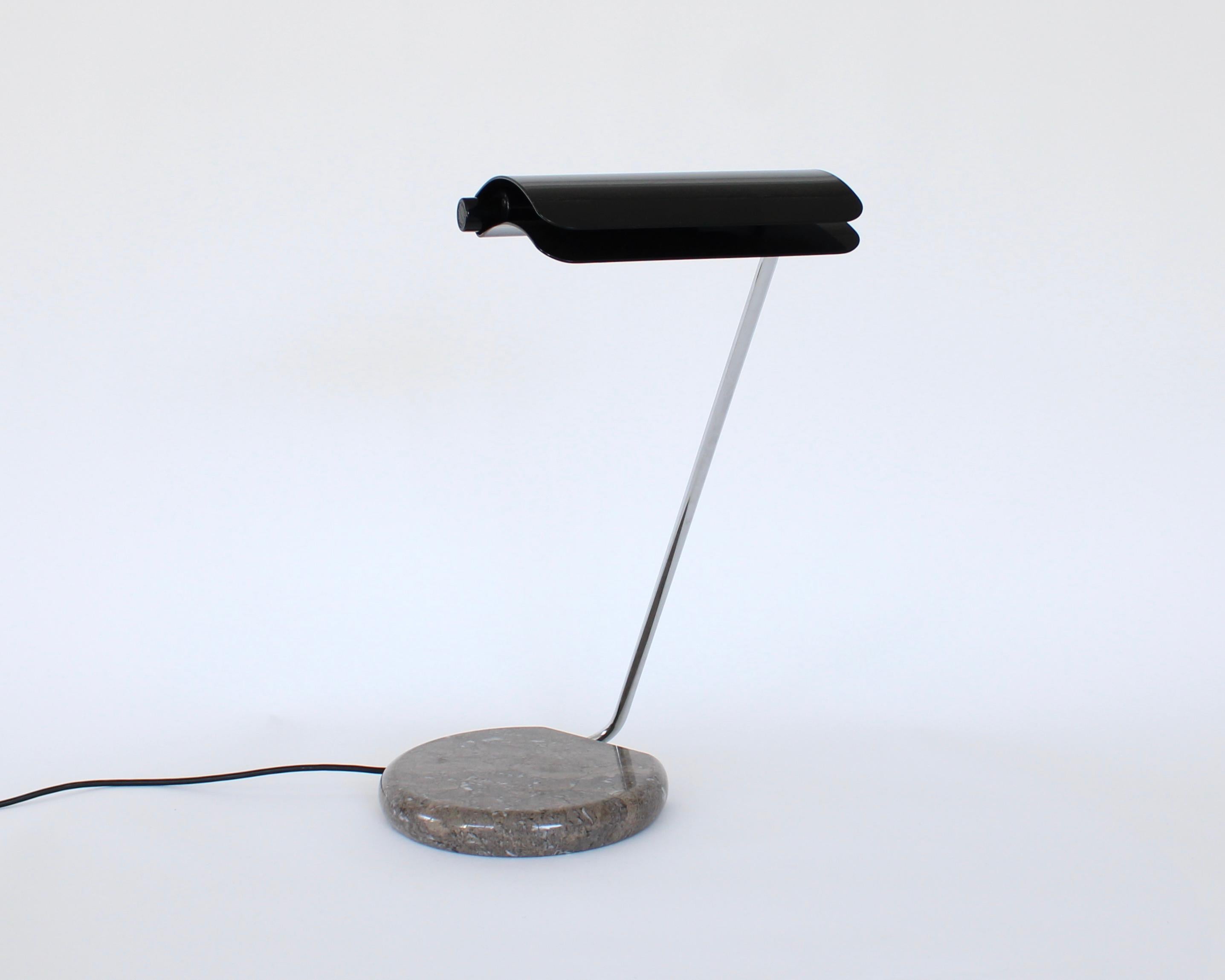 This model Tegola lamp was designed by Bruno Gecchelin for Skipper and Pollux. 
The base comes in brown Grigio marble with a black lacquered metal shade. 
Tegola means roof tile in Italian which the shade resembles.
This lamp was produced until