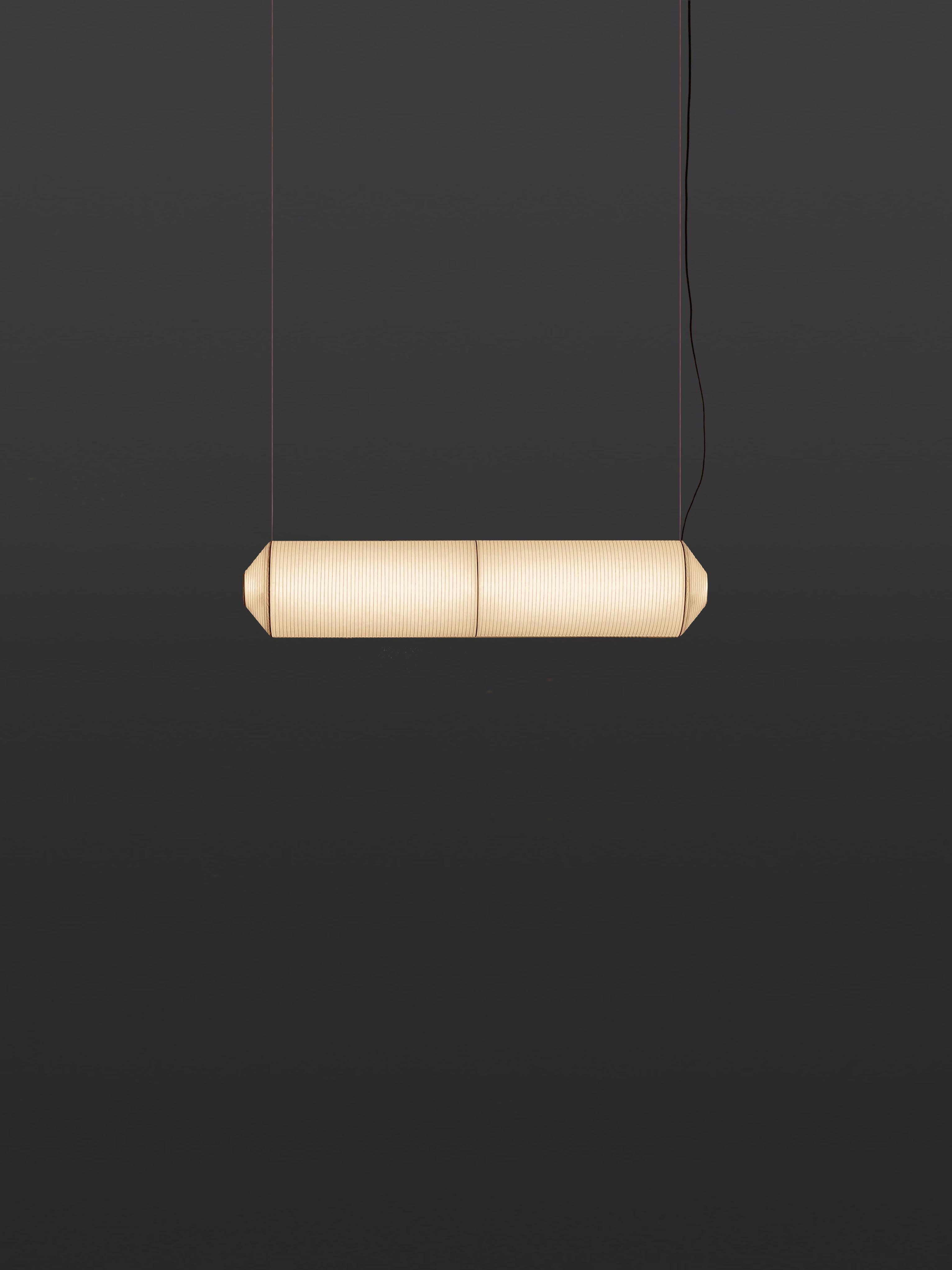 Tekiò horizontal P2 pendant lamp by Anthony Dickens
Dimensions: D 25 x W 120 x H 25 cm
Materials: Metal, Washi japanese paper shade.
Available in circular or rectangular canopy.

Tekiò, the Japanese word for adaptation, merges ancient artisan