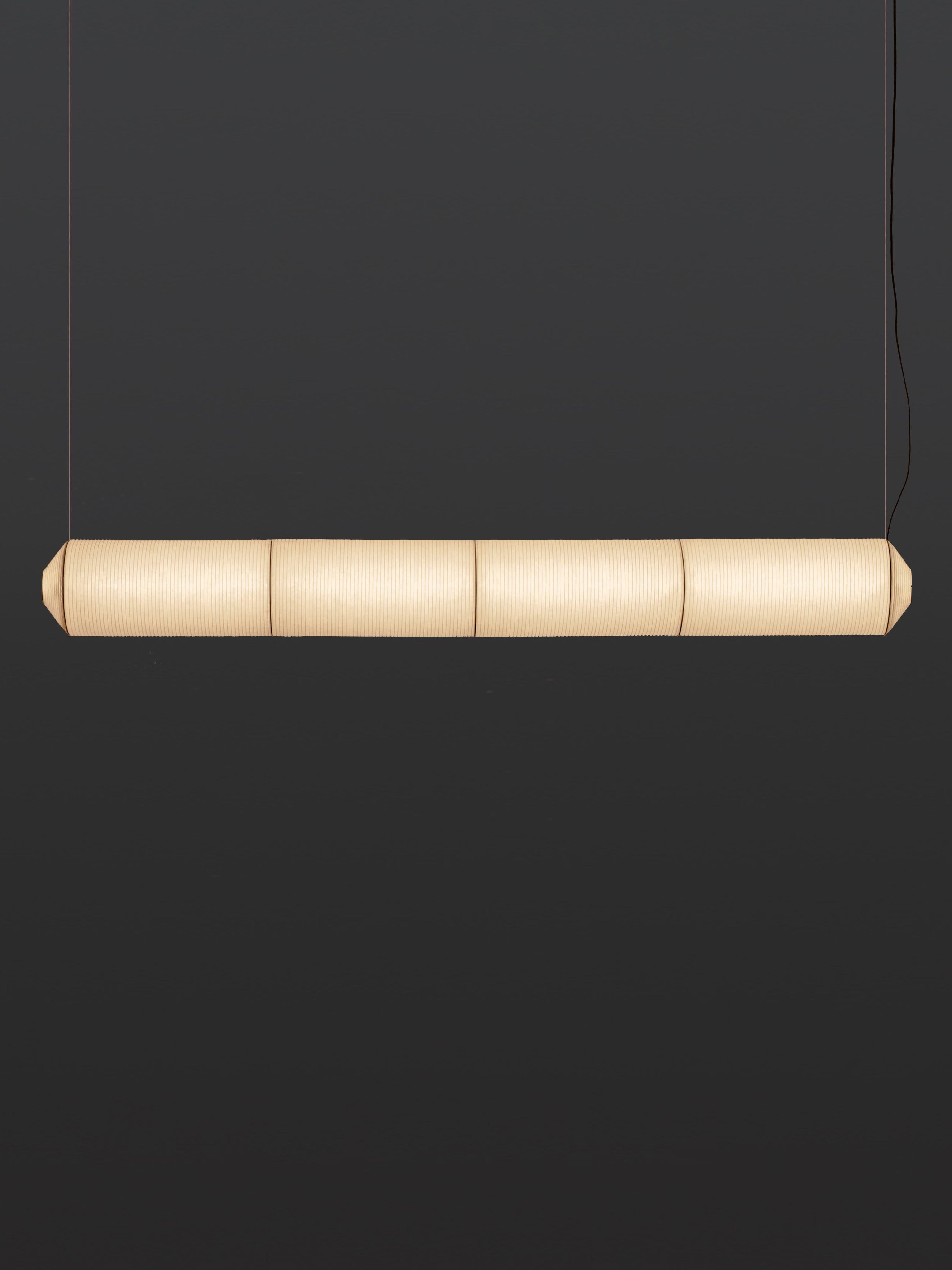 Tekiò horizontal P4 pendant lamp by Anthony Dickens.
Dimensions: D 25 x W 226 x H 25 cm.
Materials: Metal, washi japanese paper shade.
Available in circular or rectangular canopy.

Tekiò, the Japanese word for adaptation, merges ancient artisan