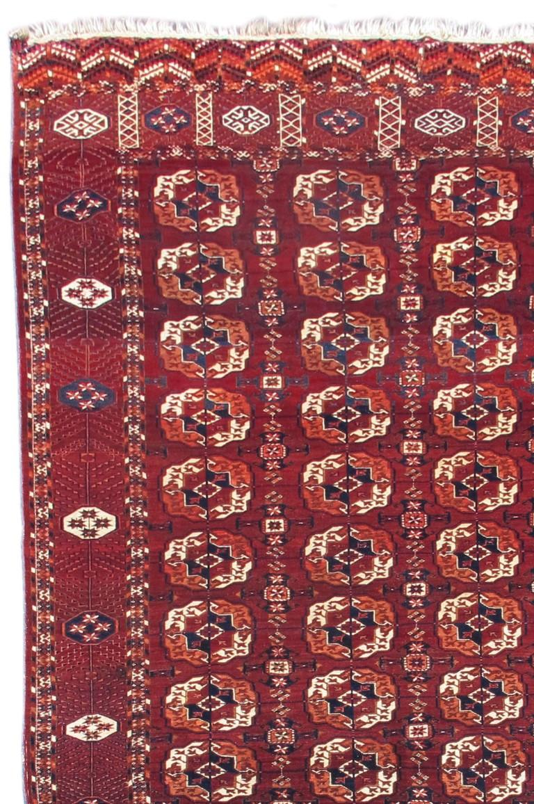 This classic Tekke Turkmen main carpet from Central Asia draws a configuration of quartered ‘guls’ alternating with cruciform ‘ghurbagheh’ or ‘frog’ type minors. This piece is longer than most of its type with twelve rows of four quartered guls. The