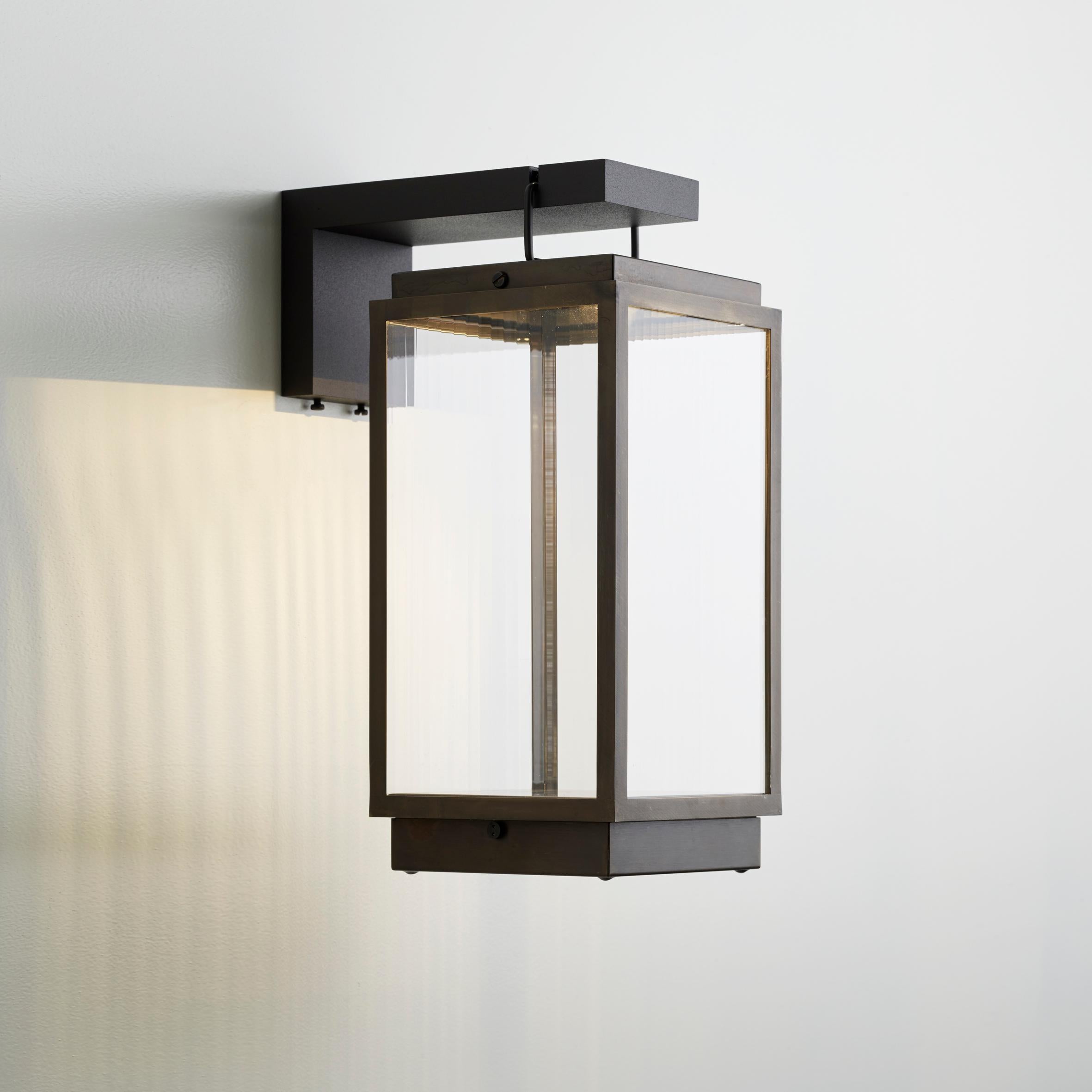 Eclectic table lamp in bronze lacquered with inside fitted glass. With bracket in aluminium, lacquered in bronze color. Supplied with rechargeable Li-ion battery at the bottom, good for a life span of seven hours after full recharge (of two hours).