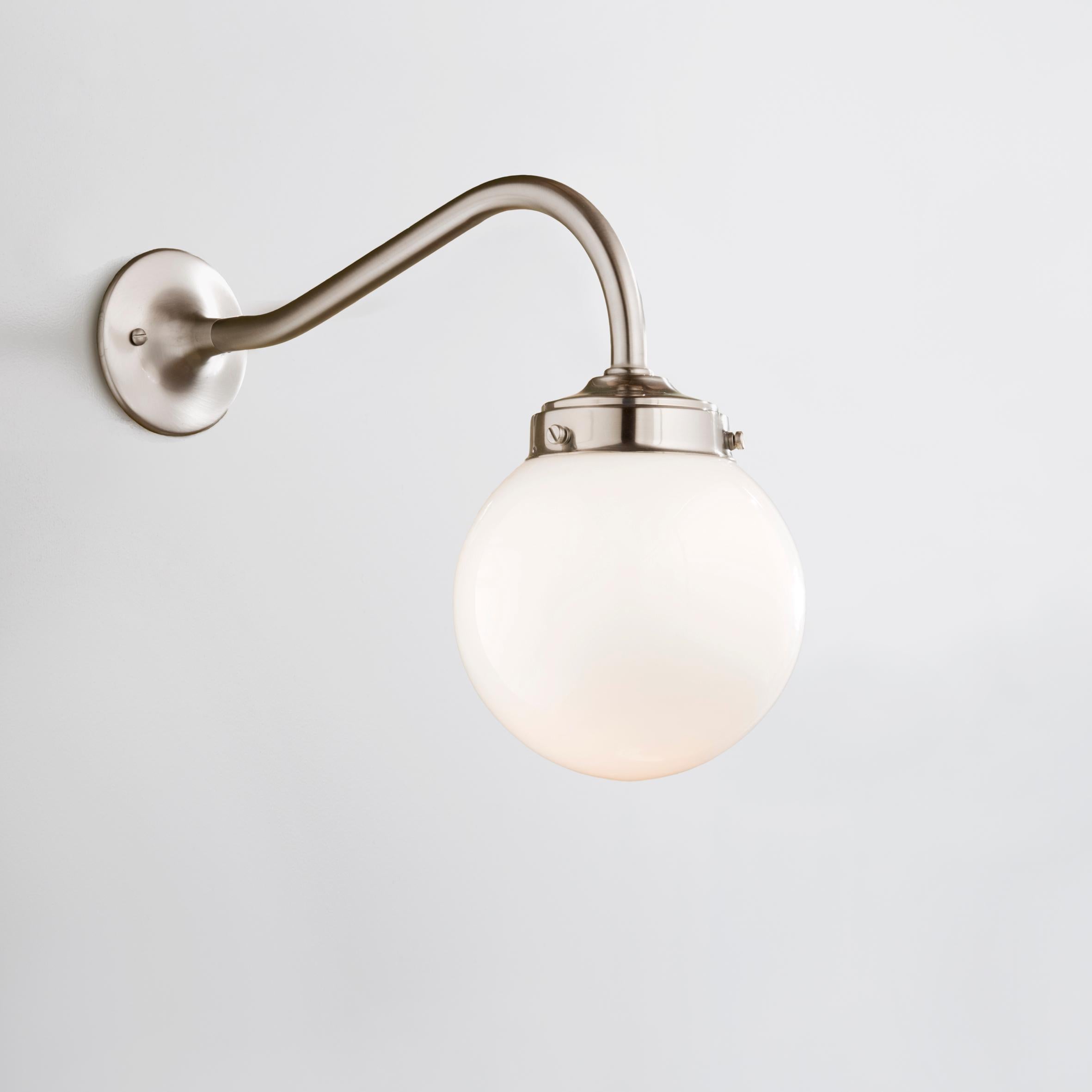 Wall light in brass, with one part ‘curved’ arm, closed gallery 3 1/4” and opal spherical glass. For indoor use only (IP42).

Lamp LED E27 230V 4W 2700K Retro A60. Main power 230V 50Hz.