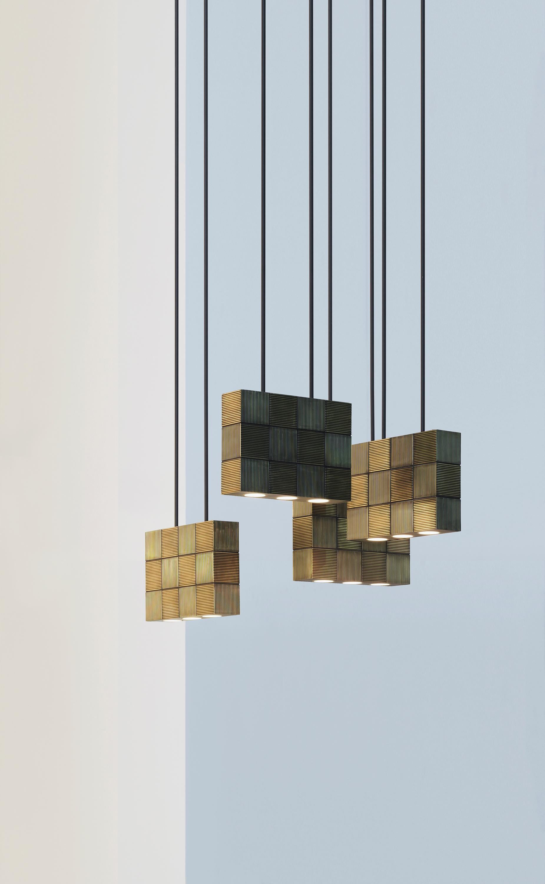 Hanging lamp in massive messing or brass covered with grooved lined tiles in checkerboard pattern. With two suspension arms (diameter 10mm) (right length to be given at order) max. 1200mm.

Dimensions: width 320mm - height 240mm - depth 80mm.
3 x