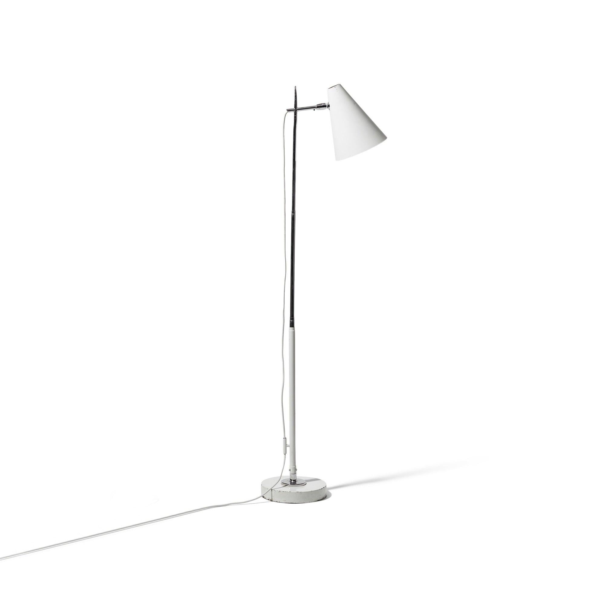 An early telescoping floor/desk lamp with a pivoting cone shade on an enameled and chromed steel stem with a ball-and-socket jointed disc base.