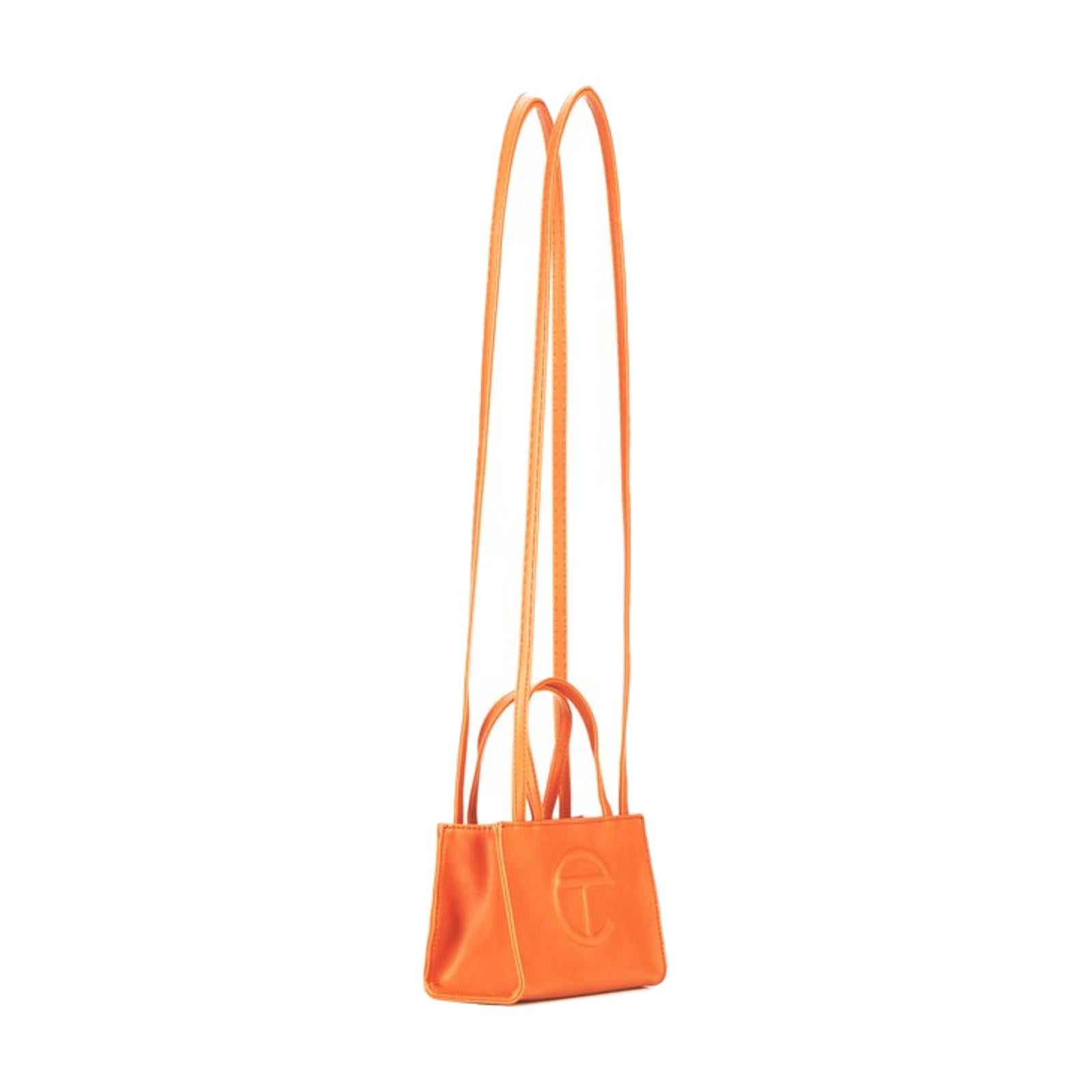 This bag is made with vegan/faux leather and twill interior lining. Featuring a double strap (handles and cross-body straps), embossed logo, and magnetic snap closure. The bag is packaged in a 100% cotton drawstring dust bag with screen printed