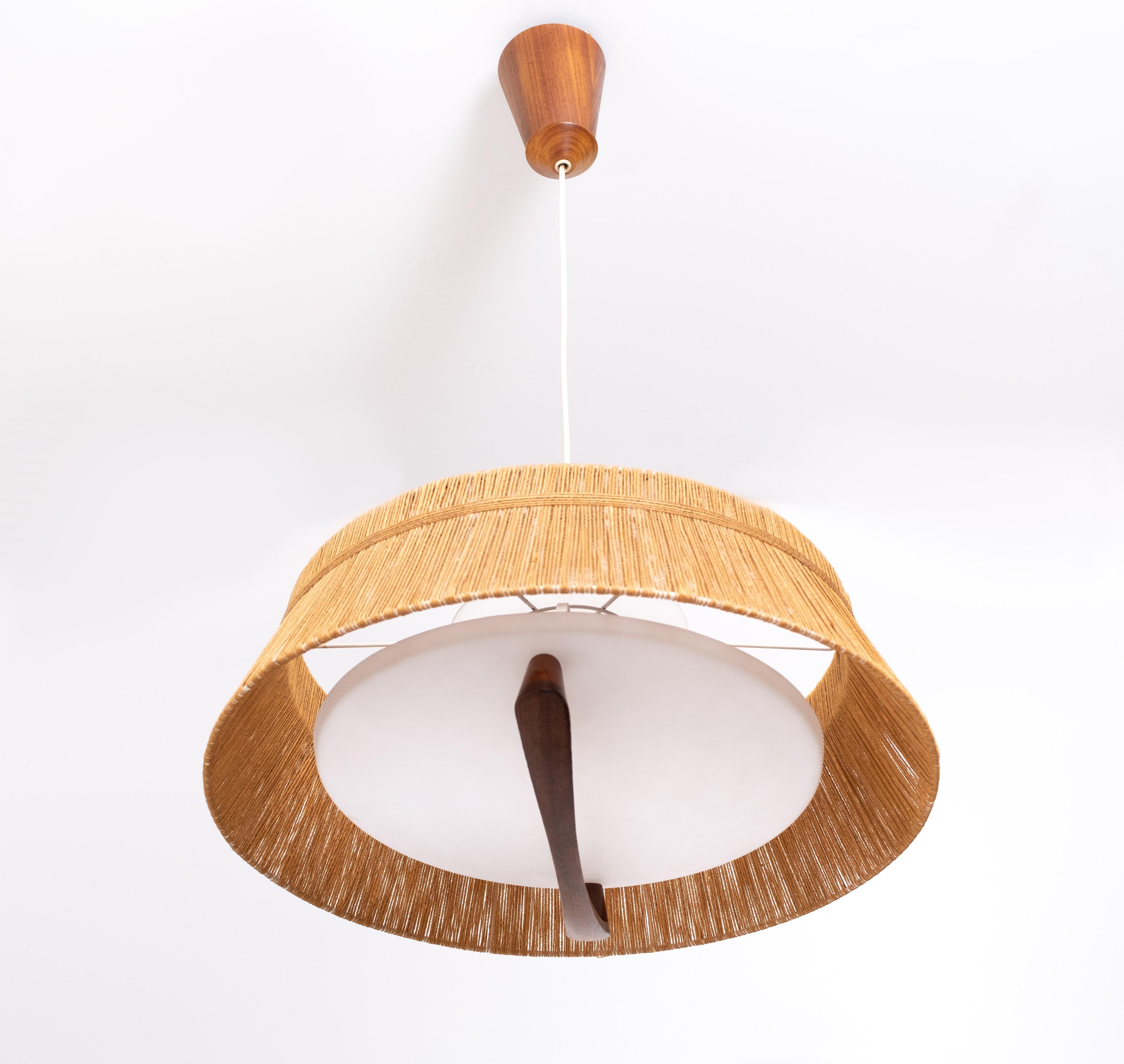 Beautiful pendant lamp by Temde, Germany, 1960. Lots off details. 2 white plexiglass plates, gives a very nice diffuse light. Solid teak ceiling piece and Handle. The raffia shade is vulnerable, this one is still in a very good condition.
 