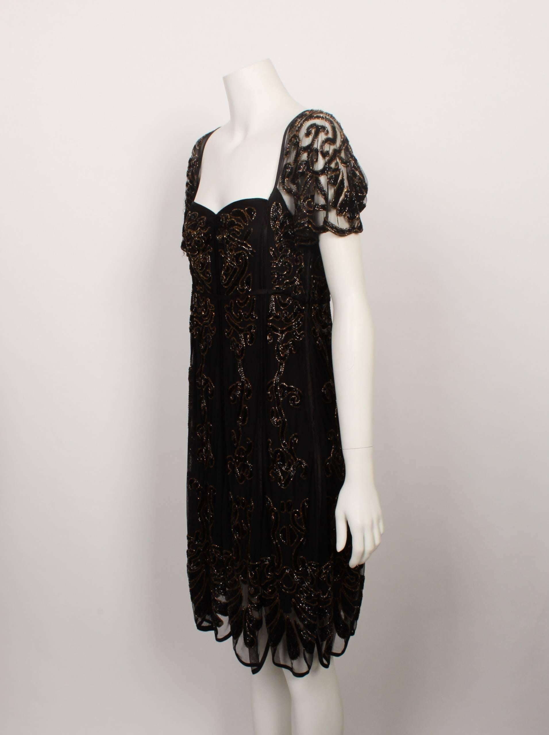 Stunning and timeless Temperely London beaded black veil cocktail dress with scalloped hemline. Delicate veil panels are heavily beaded in black and gold beads. Each panel has satin bound edging. The front neckline is a soft sweetheart shape, and